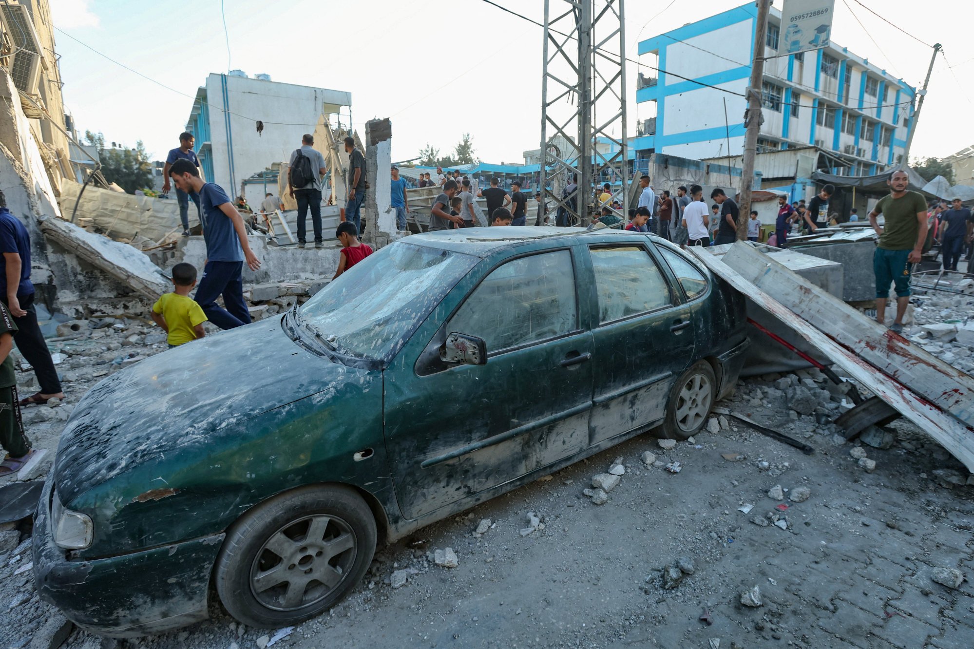 Palestinians gather at the site of an Israeli air strike in al-Nuseirat on Saturday. Photo: Reuters