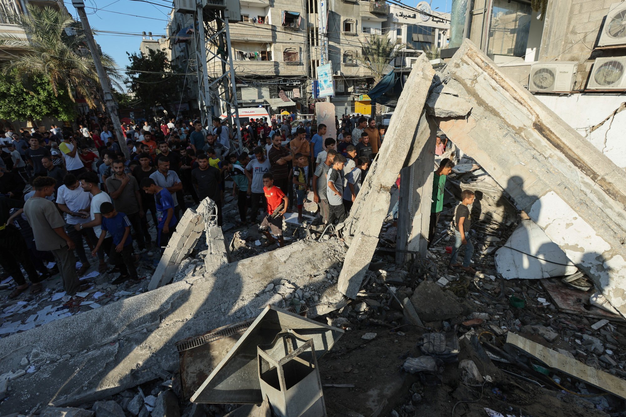 Palestinians gather at the site of an Israeli air strike on a school sheltering displaced people in al-Nuseirat in central Gaza Strip on Saturday. Photo: Reuters