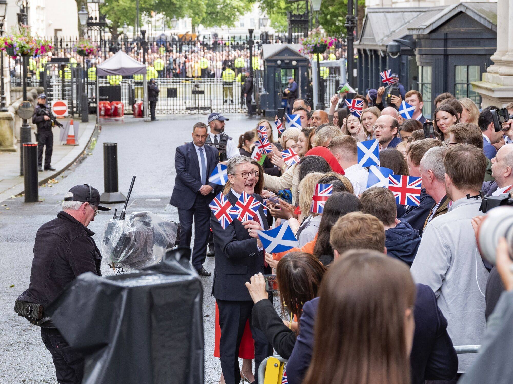 UK Prime Minister Keir Starmer greets supporters in London on July 5 after the Labour Party’s landslide victory which ended 14 years of Conservative rule. Photo: Bloomberg