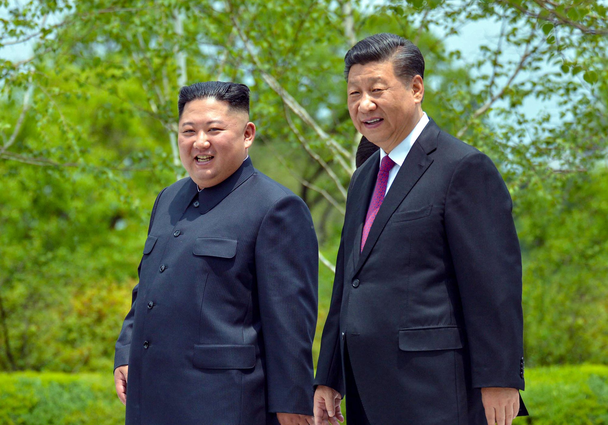 Chinese President Xi Jinping, right, and North Korean leader Kim Jong-un walk during Xi’s visit to Pyongyang on June 21, 2019. Photo: KCNA via Reuters