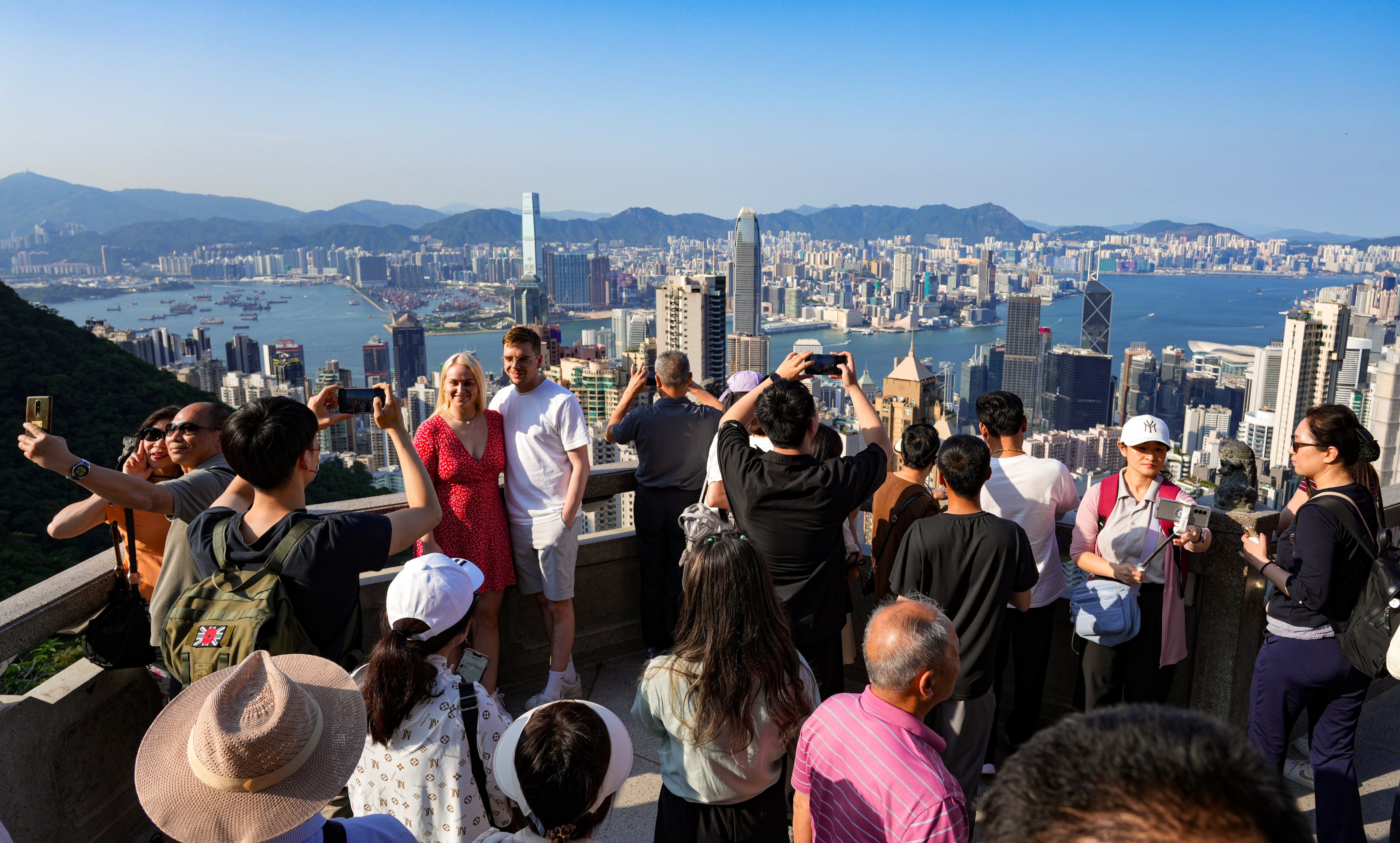 Visitors to The Peak enjoying views of Hong Kong Island and the Kowloon peninsula. Photo: May Tse