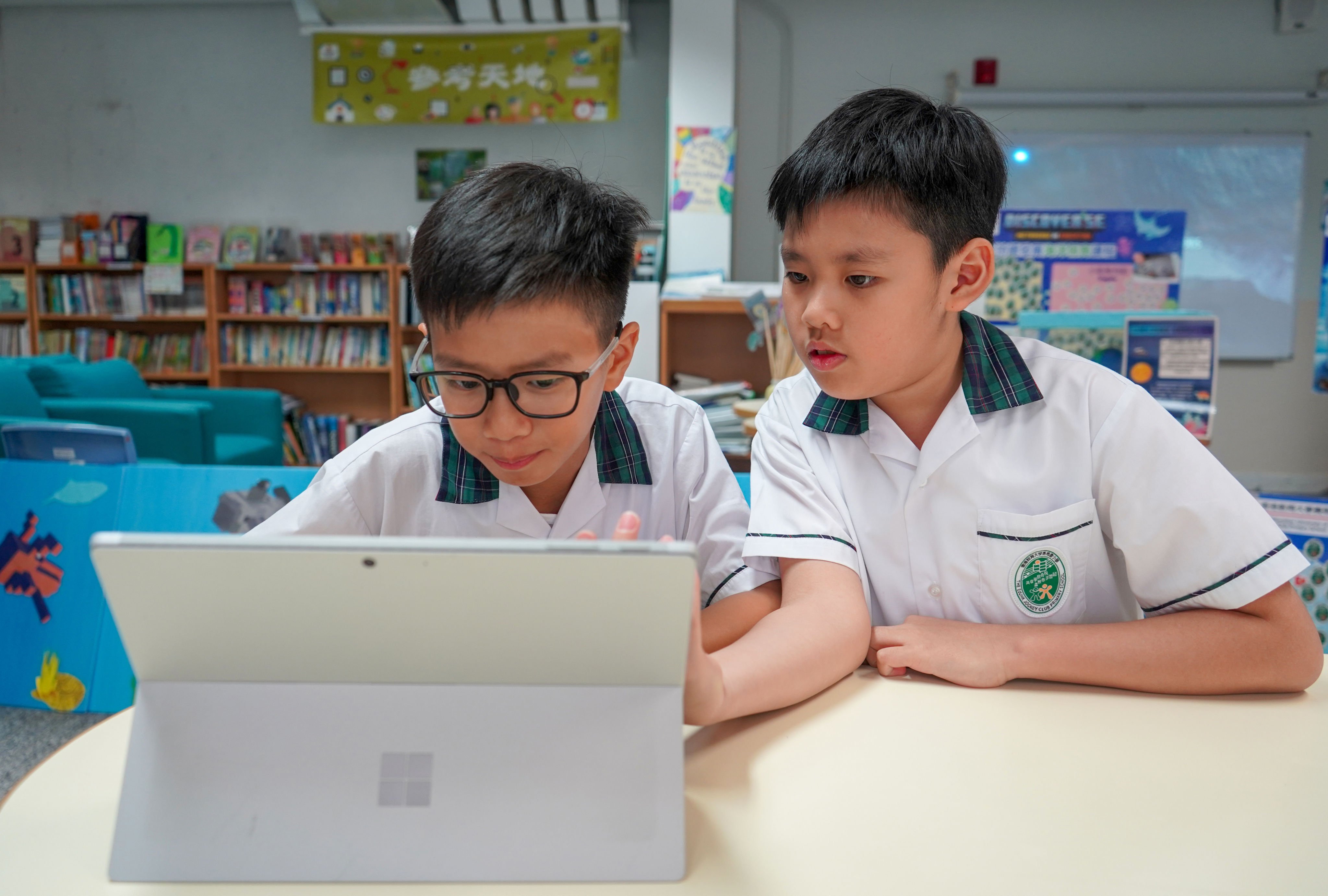 Education University of Hong Kong Jockey Club Primary School students Hoie Tong and Johnny Wong use Microsoft’s AI platform on the company’s Surface computer on July 2, 2024. Photo: Kelly Le