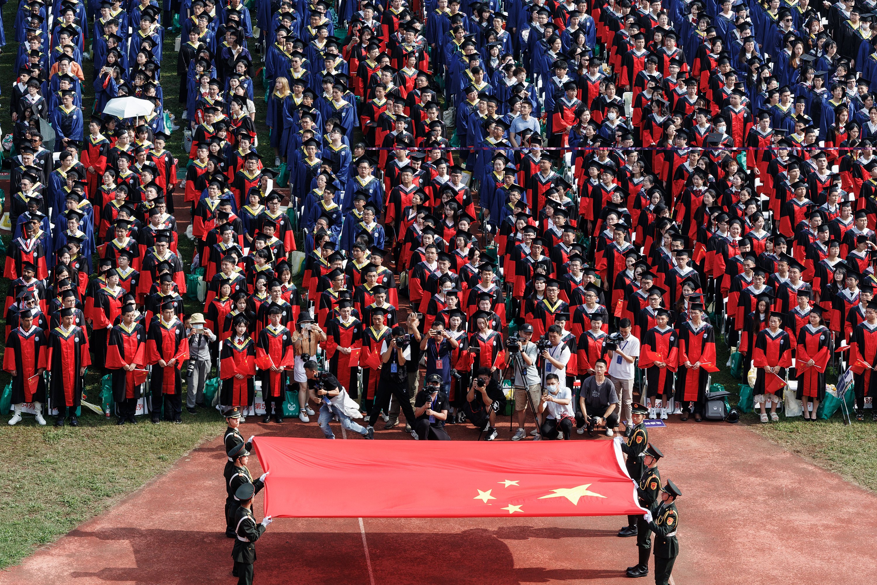 Despite recent lay-offs and pay cuts, salaries in the finance industry remain among the highest in China, with the sector continuing to be one of the most coveted career paths for graduates. Pictured are students at their graduation ceremony at Wuhan University. File photo: dpa