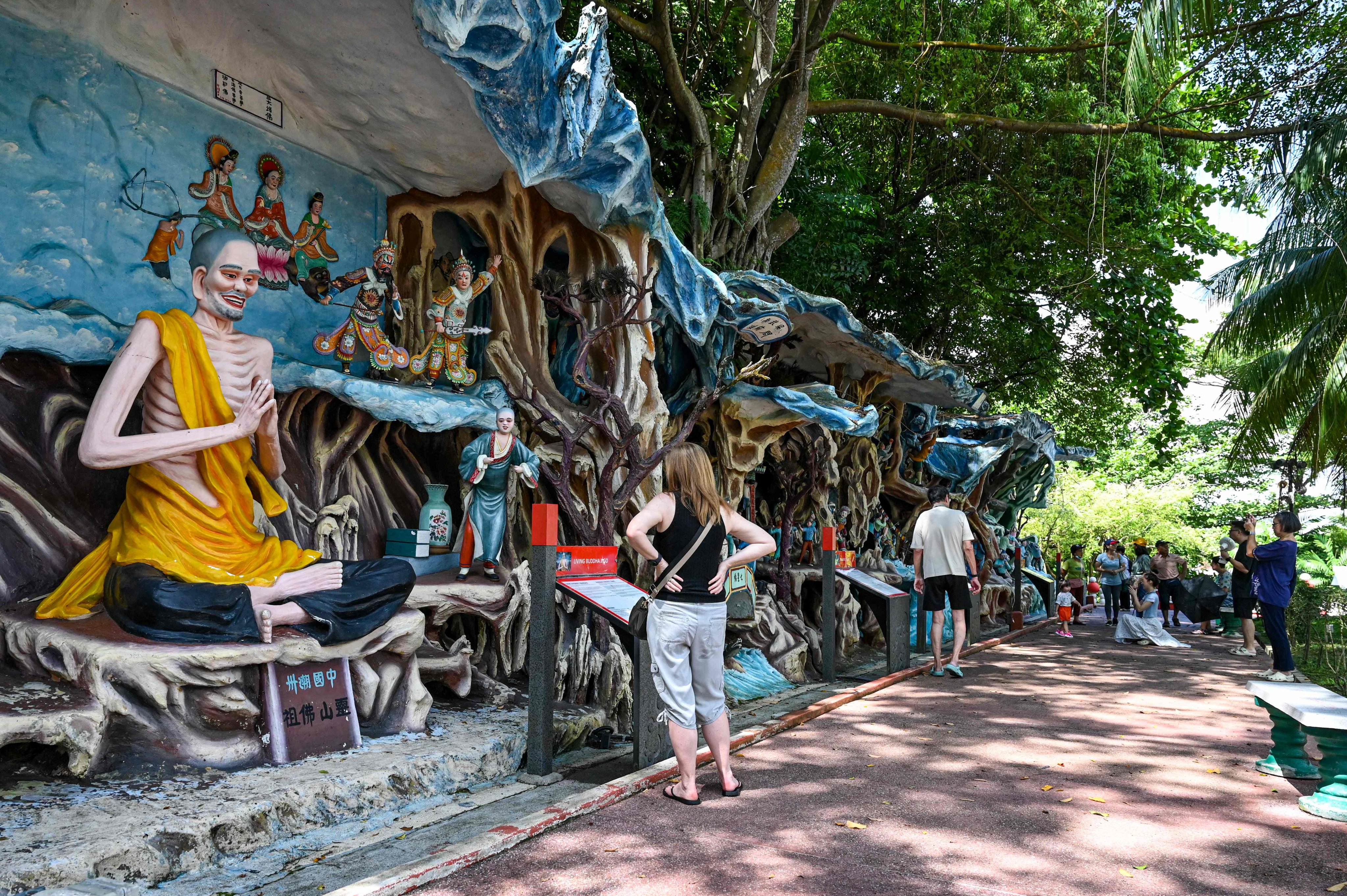 Visitors walking past statues at Haw Par Villa, an Asian cultural park that features Chinese folklore, legend and mythology in Singapore. Photo: AFP