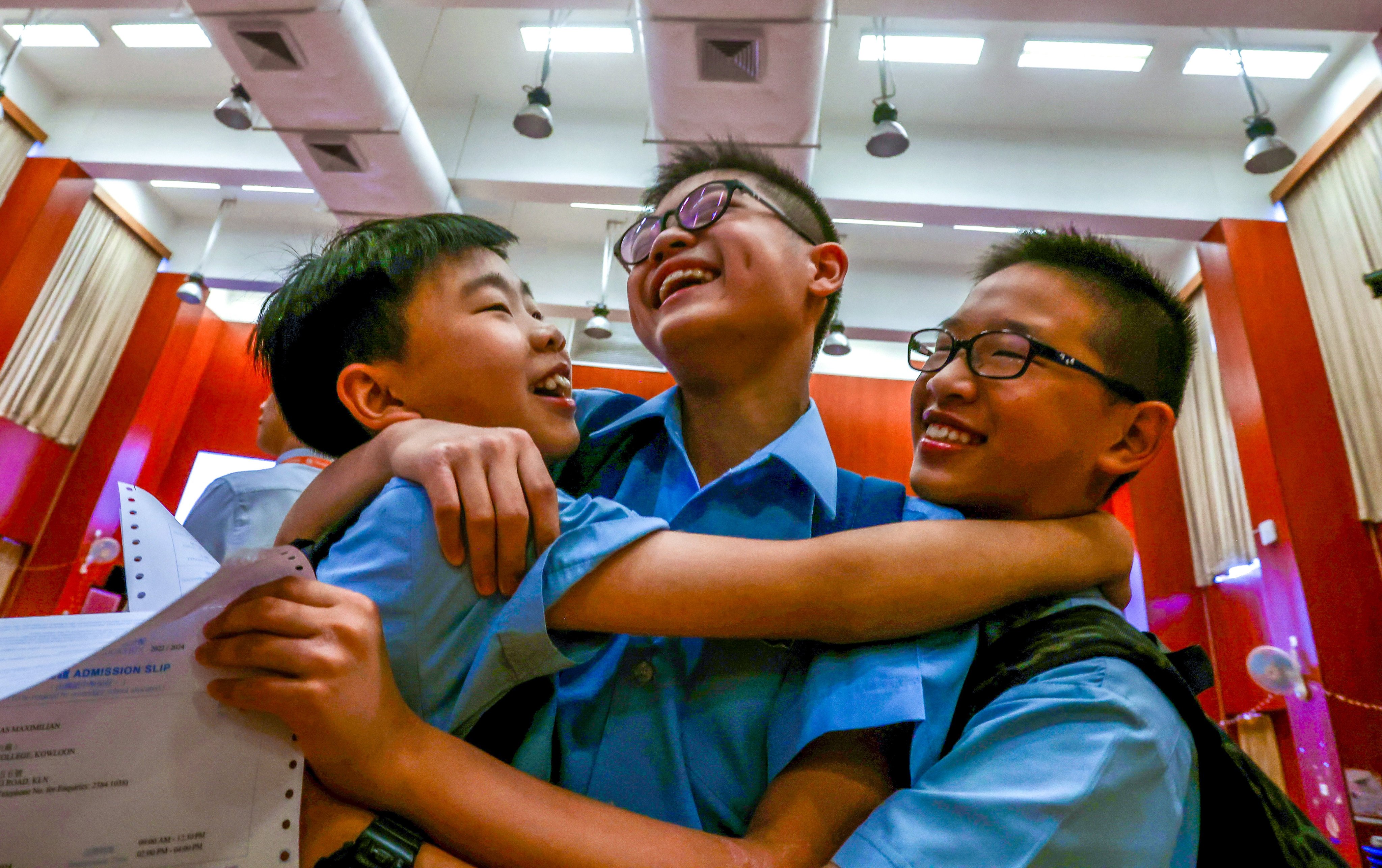 Students (from left) Kardan Ngai, Maximilian Wong and Caspar Wu celebrate their school allocation results. Photo: Jonathan Wong
