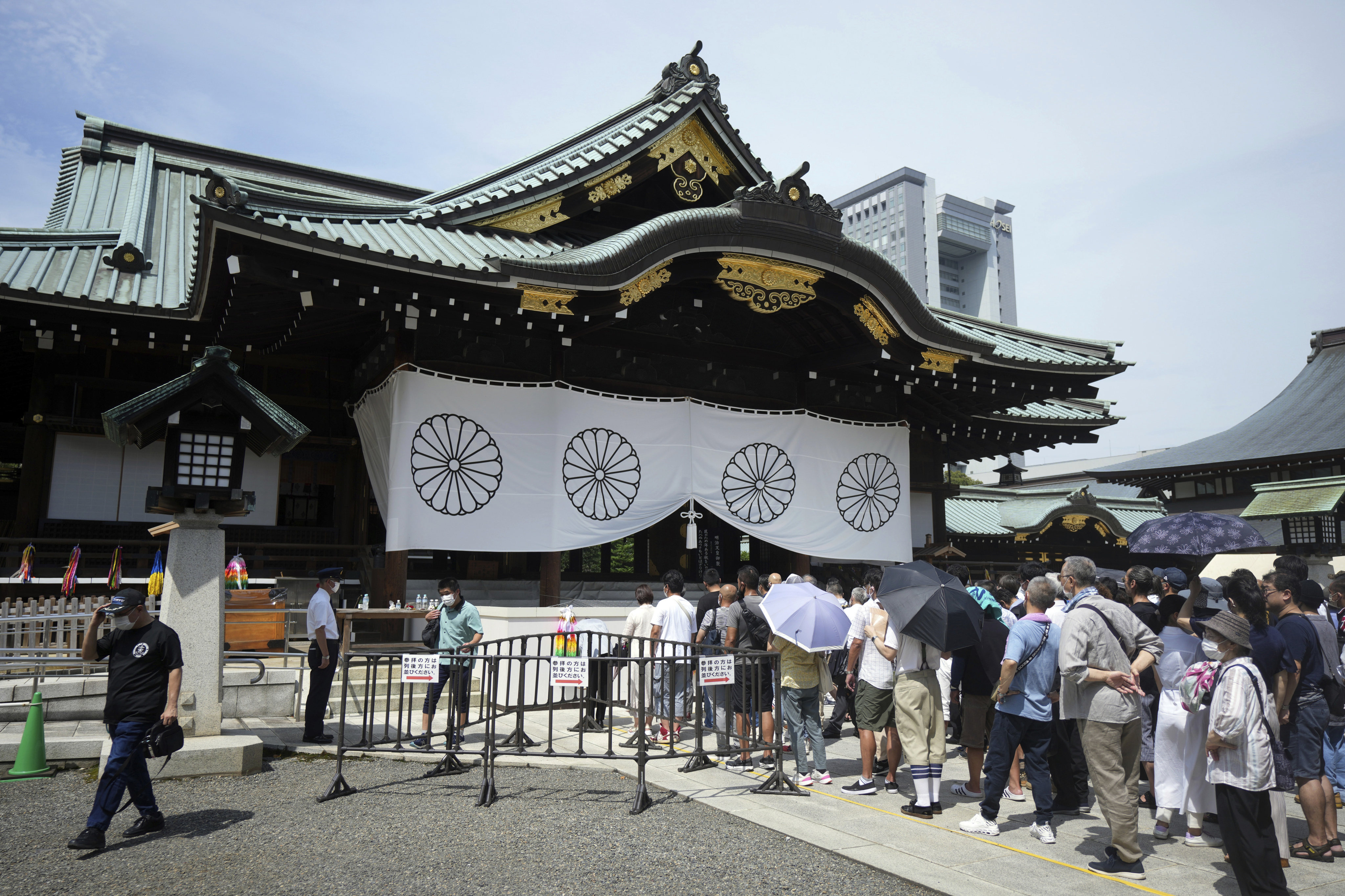 People pay respects to the war dead at Yasukuni Shrine in Tokyo. A Chinese man was arrested on Tuesday for his alleged involvement in spray-painting graffiti on the shrine. Photo: AP