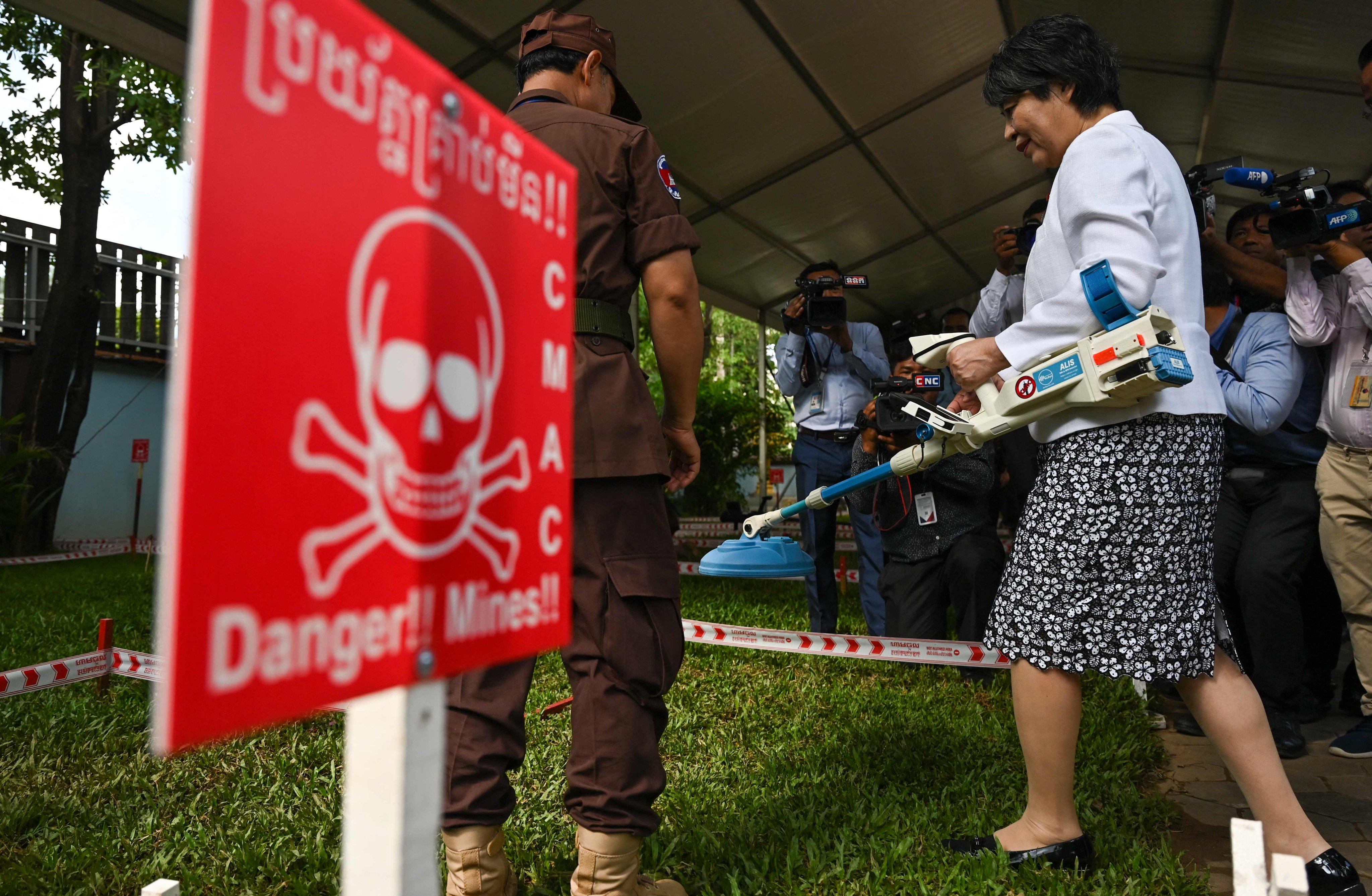 Japan’s Foreign Minister Yoko Kamikawa holds a mine detector during her visit to the Cambodian Mine Action Centre in Phnom Penh on Saturday. Photo: AFP