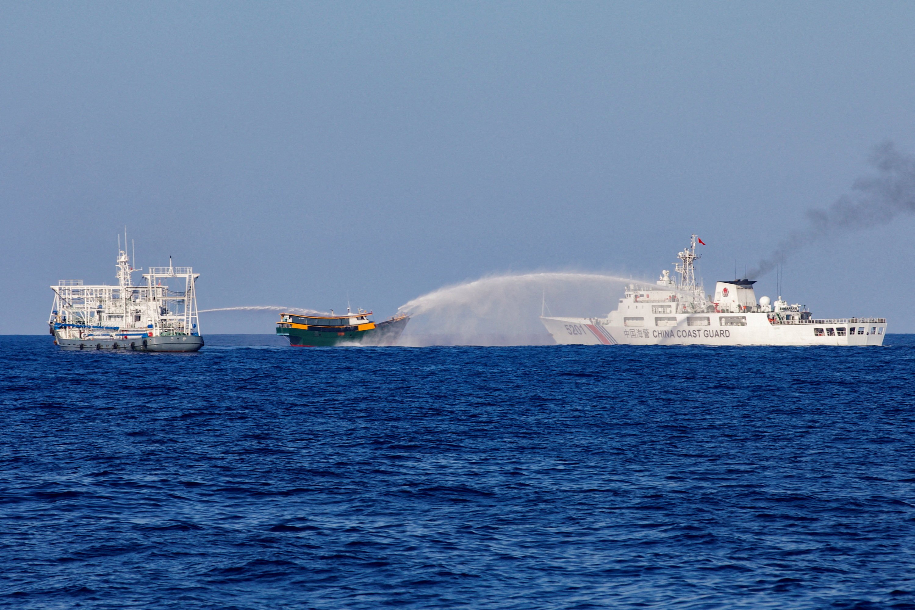 Chinese coastguard ships fire water cannons towards a Philippine resupply vessel on a resupply mission to Second Thomas Shoal in the South China Sea in March. Photo: Reuters