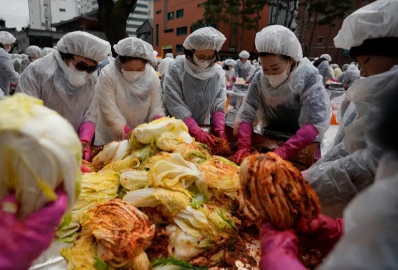 Women prepare cabbage at an Asian market. The food is given different names across the region. Photo: TVBS