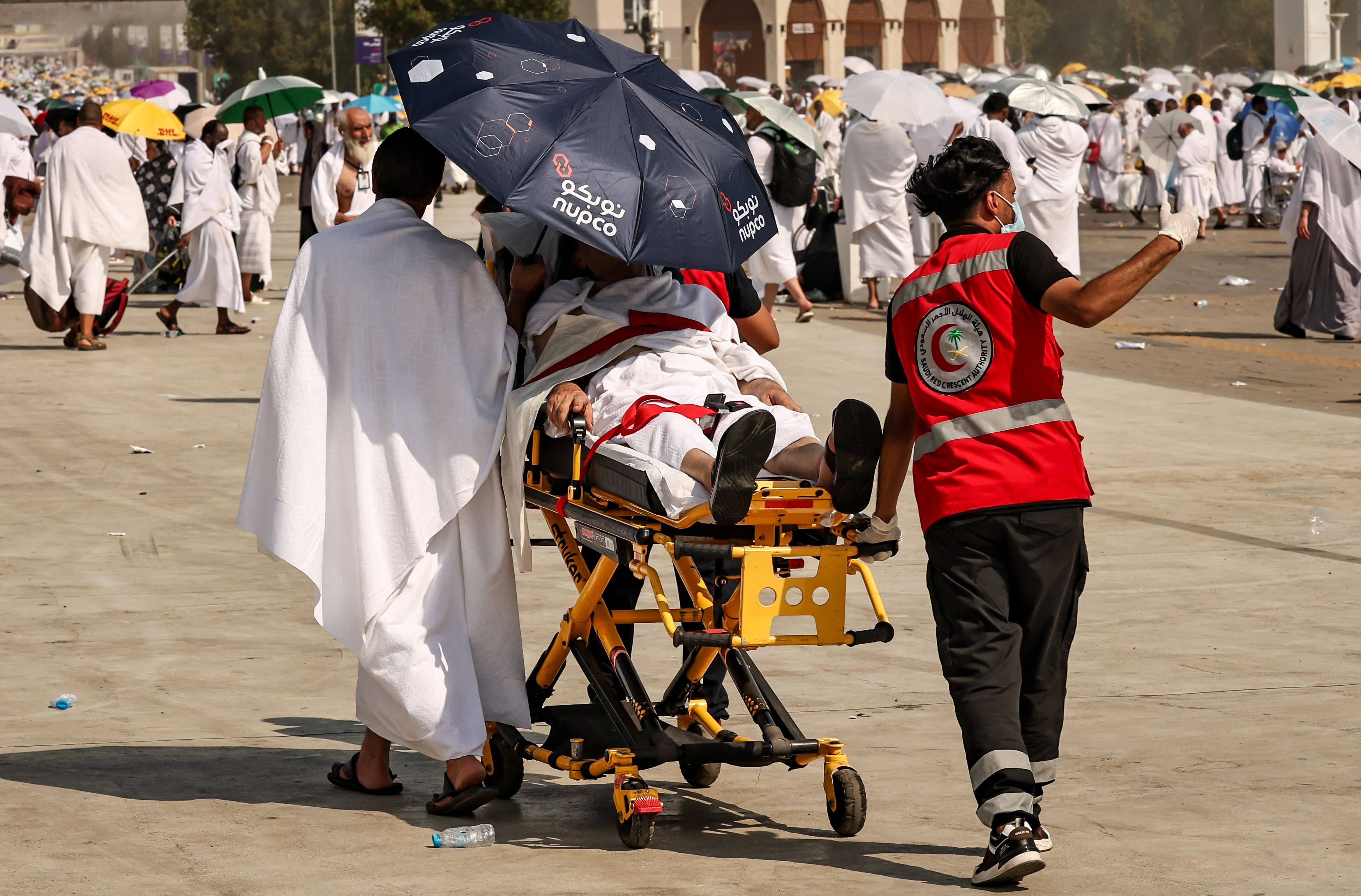 Medics evacuate a pilgrim affected by scorching heat at the base of Mount Arafat during the annual haj on June 15. Saudi Arabia has said more than 1,300 faithful died during the pilgrimage. Photo: AFP

