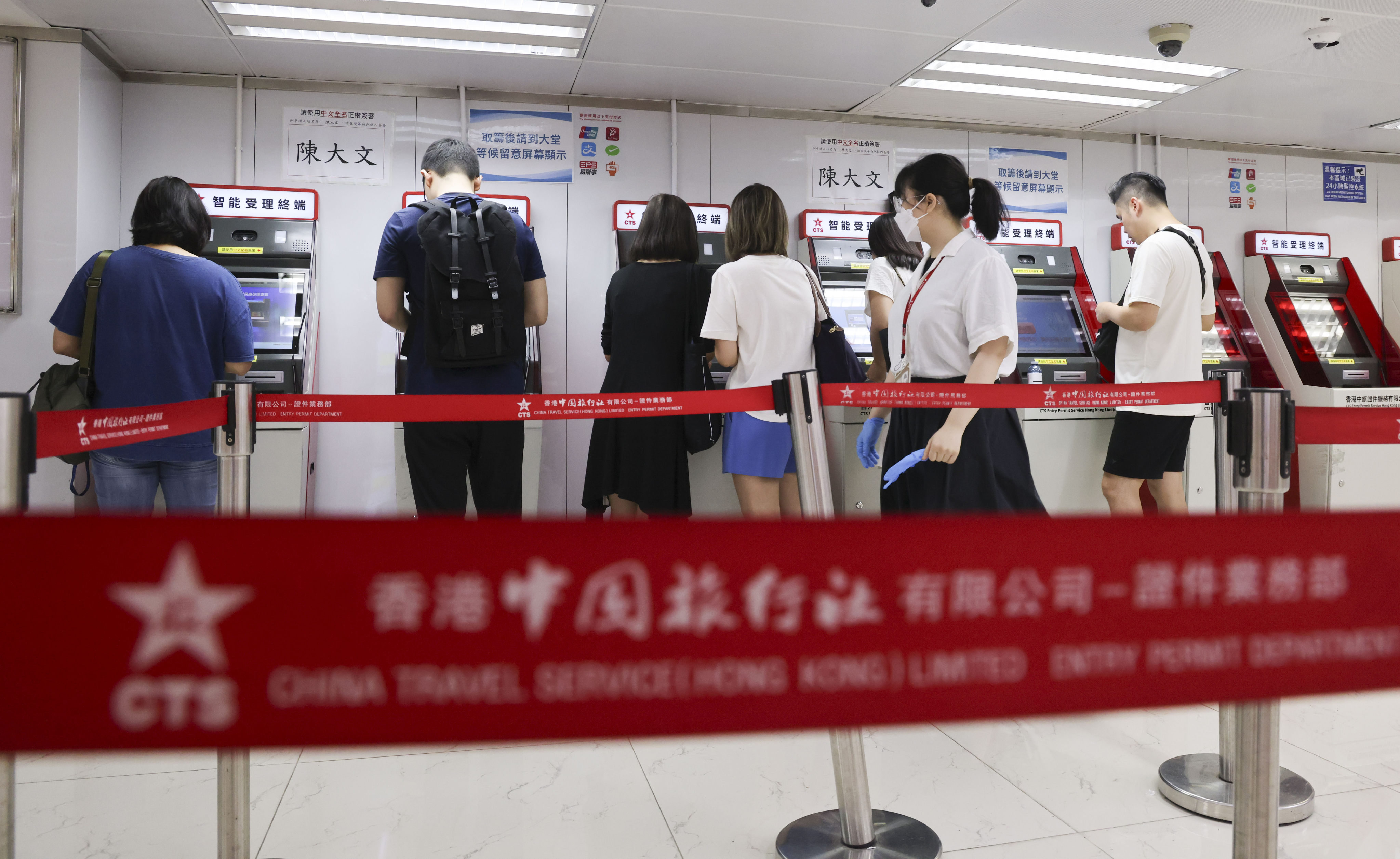 Hongkongers apply for a home visit permit at the China Travel Service Mong Kok Entry Permit Service Centre on July 2. A new scheme now allows non-Chinese permanent residents in Hong Kong and Macau to apply for visa-free travel permits to the mainland. Photo: Jelly Tse