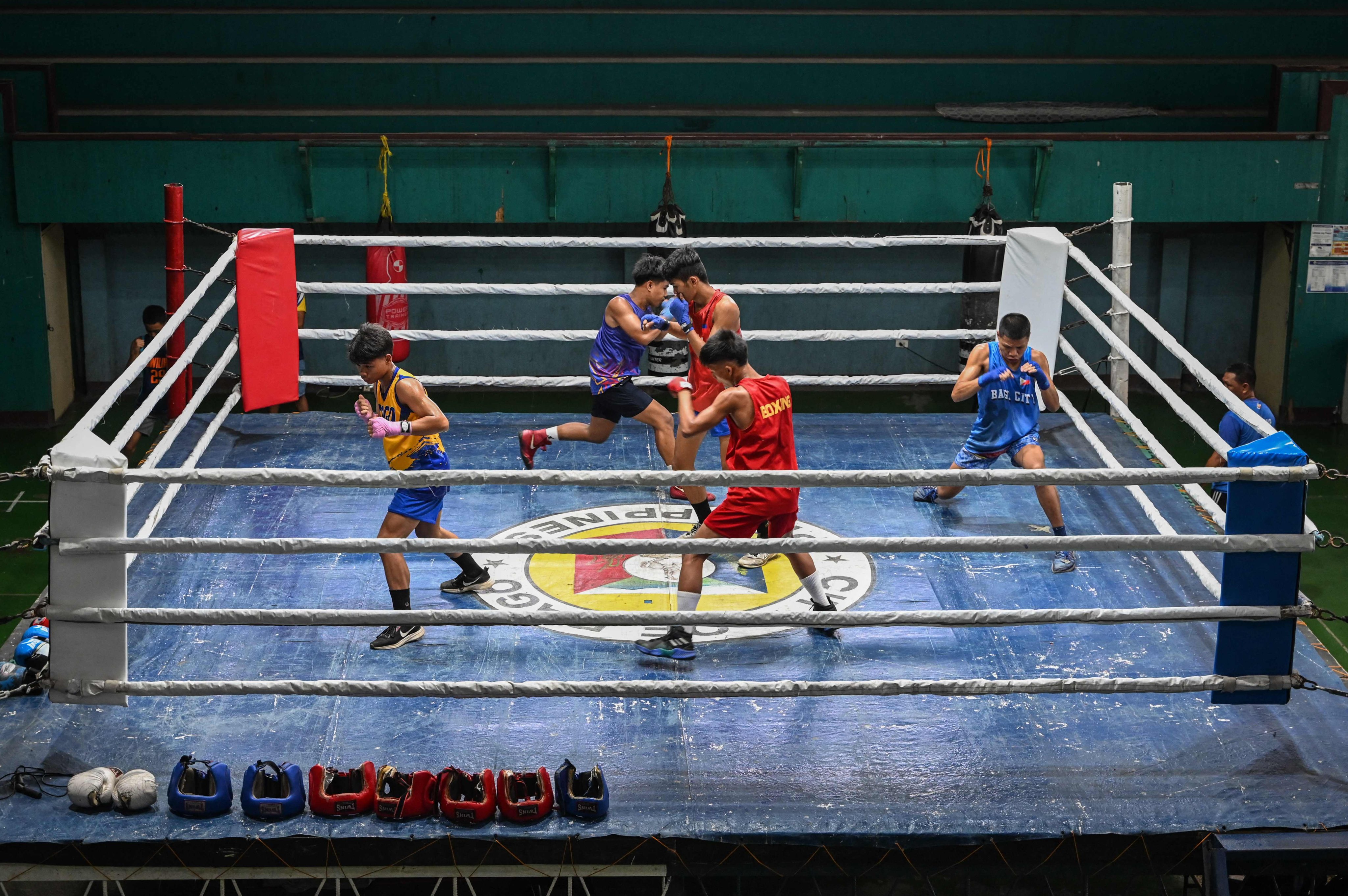 Youths shadow boxing in the ring during training at a boxing gym in Bago City. Photo: AFP