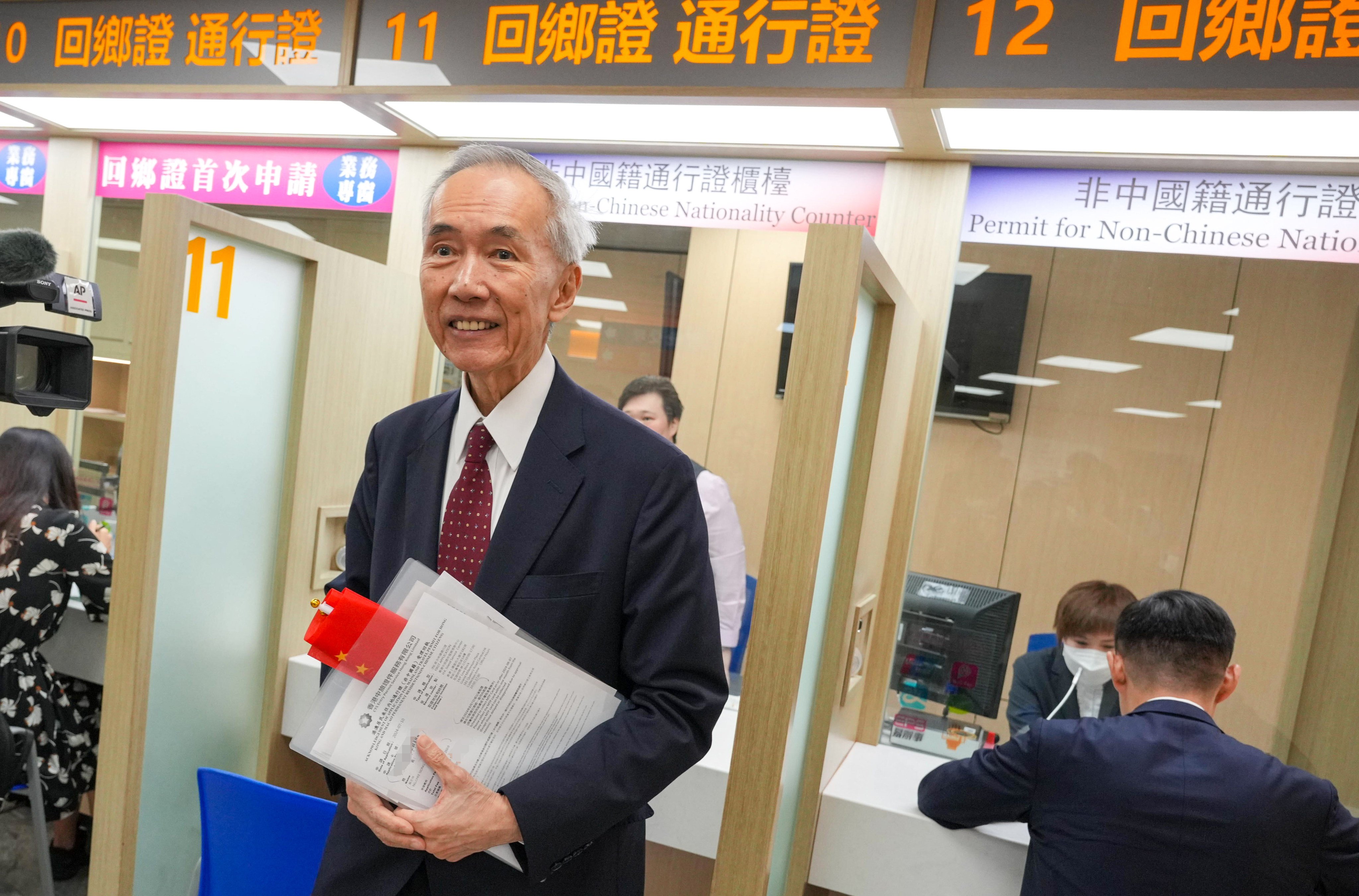 Sino Group chairman Robert Ng applies for the new mainland China travel permit on Wednesday. Photo: May Tse