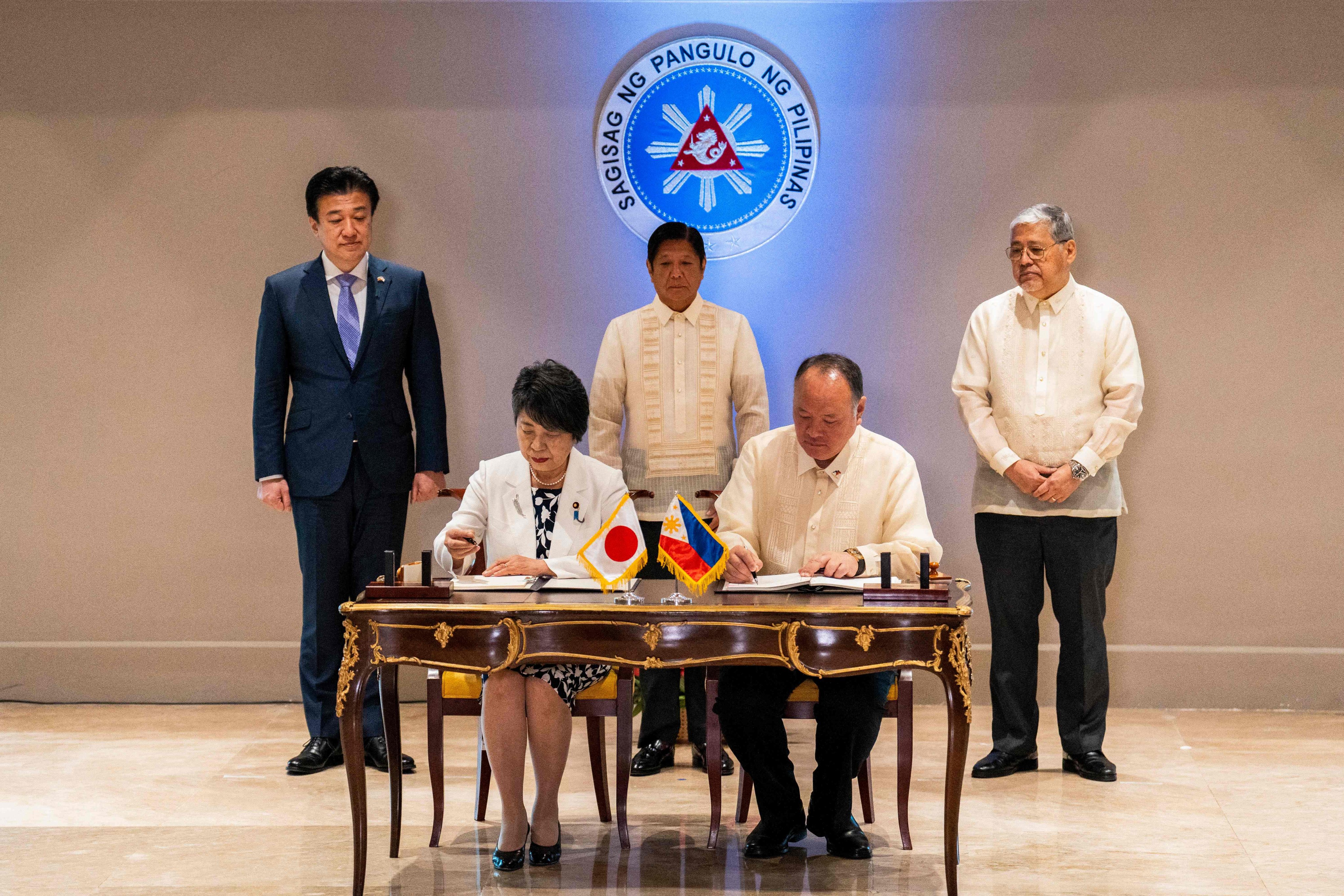 Japanese Foreign Minister Yoko Kamikawa (front, left) and Philippine Defence Secretary Gilberto Teodoro (front, right) sign a key defence pact in Manila on Monday. Photo: AFP