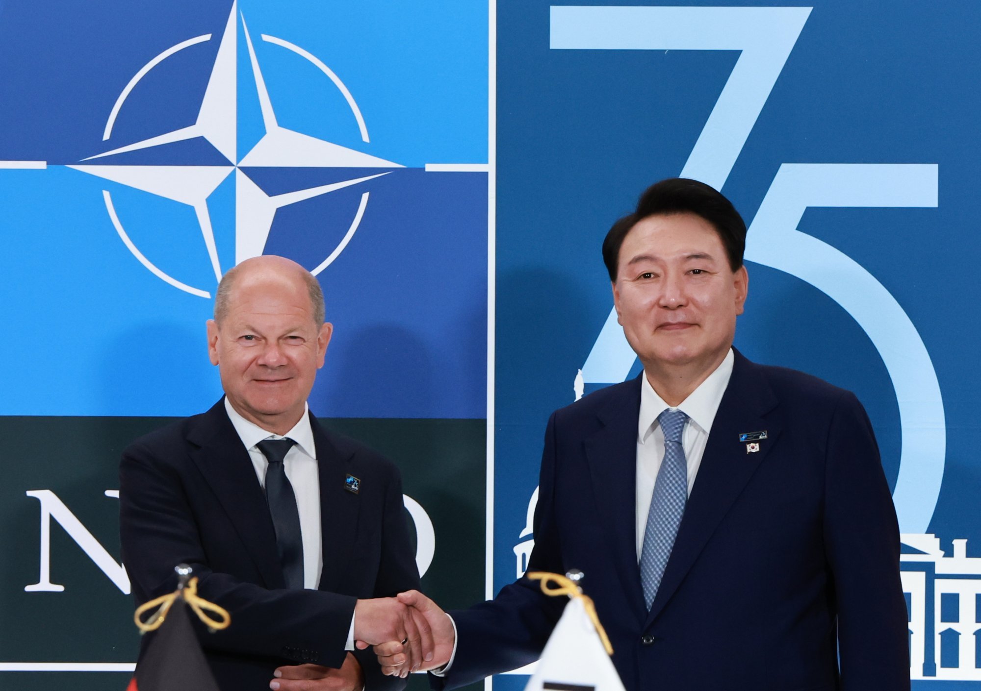South Korean President Yoon Suk-yeol and German Chancellor Olaf Scholz shake hands during their meeting on the sidelines of the Nato summit in Washington. Photo: EPA-EFE