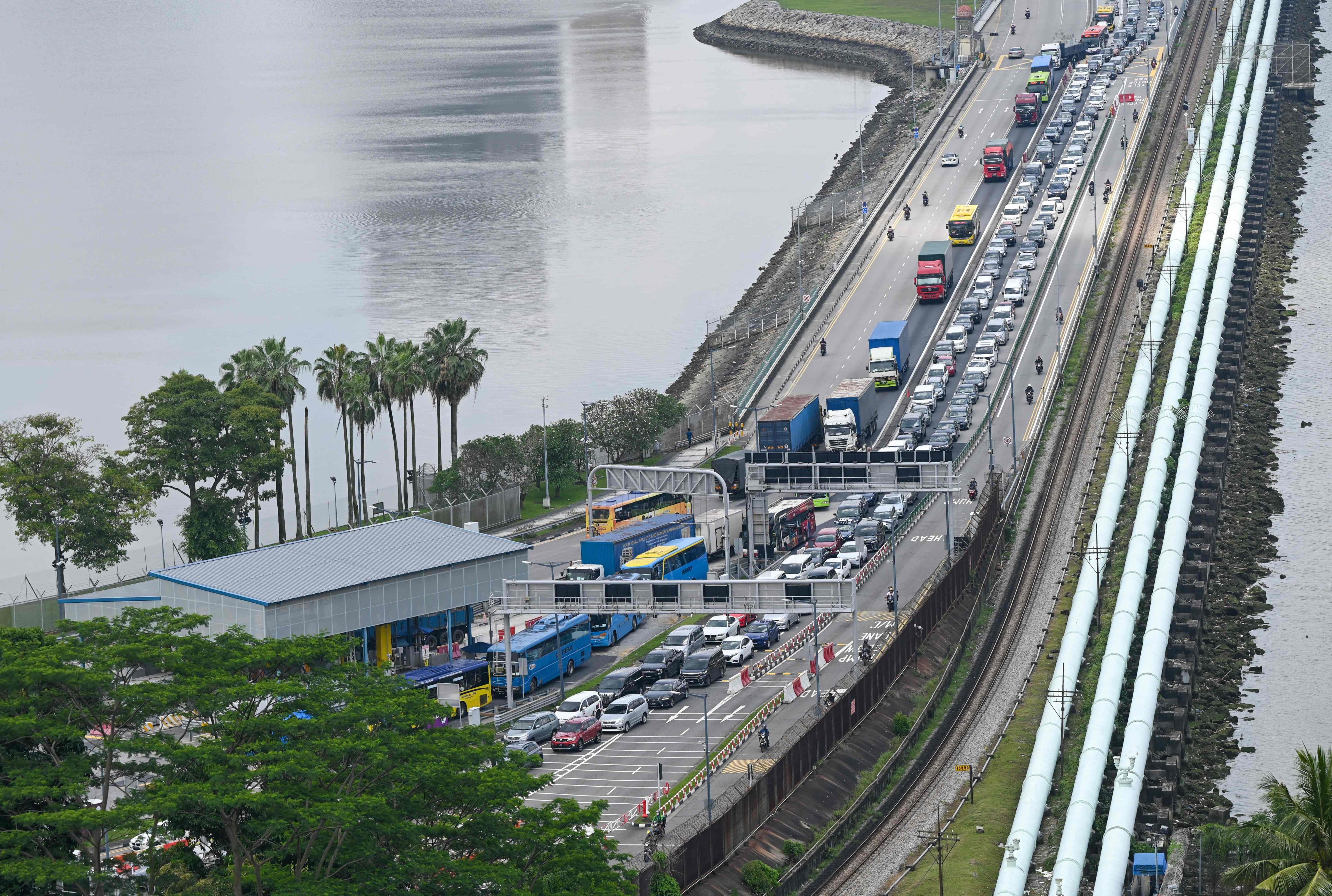 Motorists coming from Malaysia’s state of Johor form a queue as they approach the immigration checkpoint to enter Singapore in March 2023. Photo: AFP