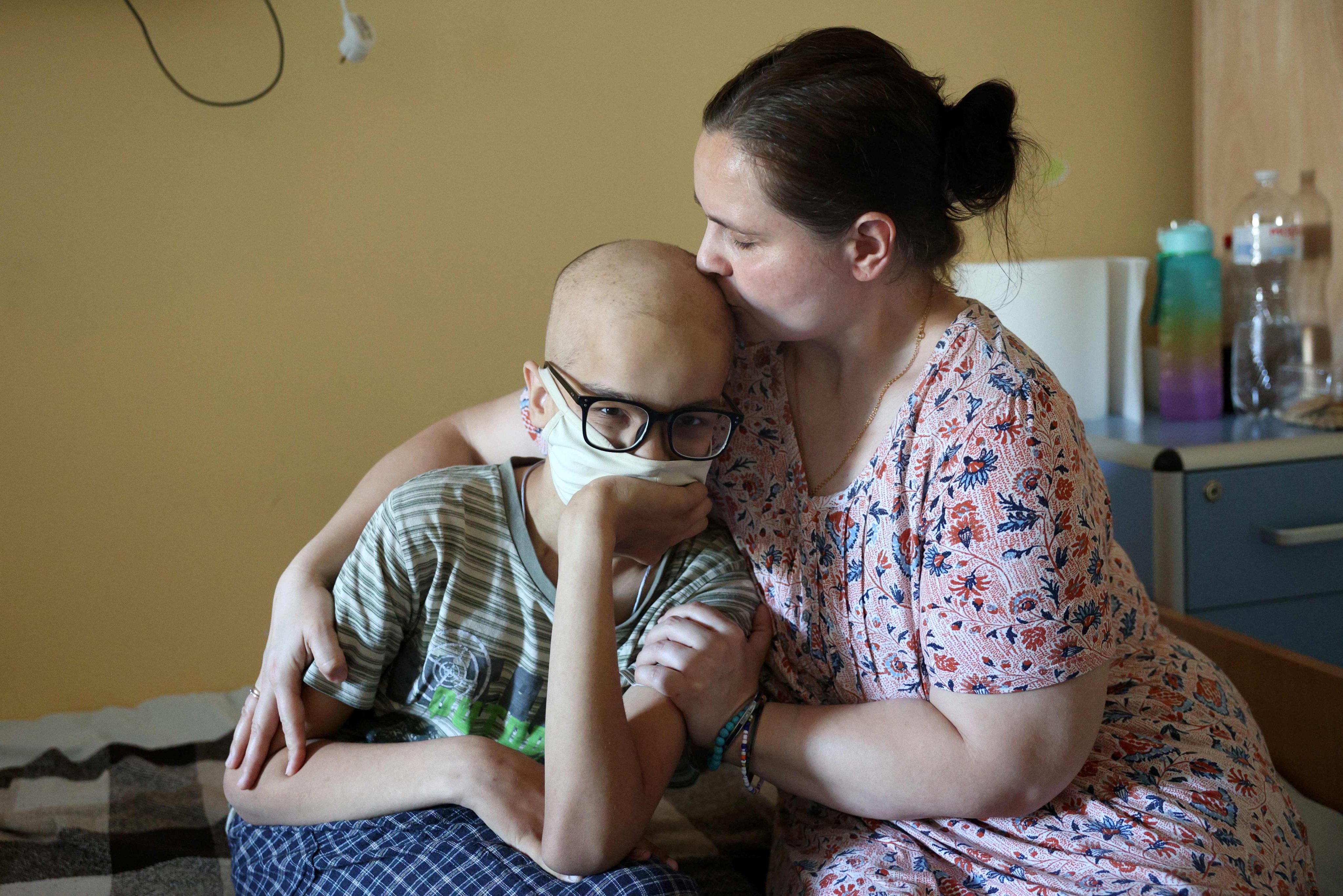 Iryna Vyshnikina kisses her son Dmytro, 13, in a Kyiv hospital on Friday. They were transferred to the National Cancer Institute after a Russian missile attack on Okhmatdyt Children’s Hospital on Monday. Photo: AFP