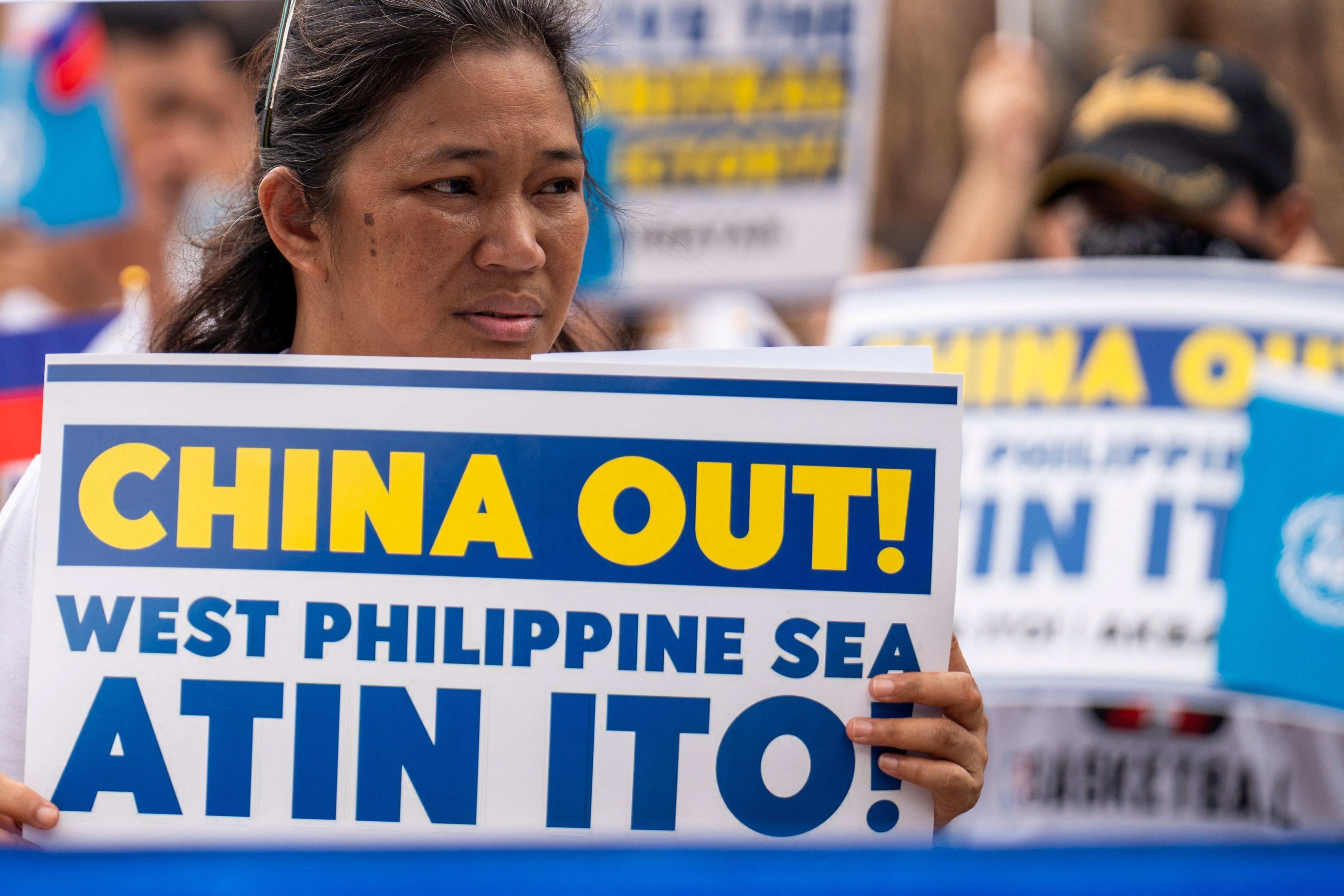 A woman holds a placard during a protest marking the eighth anniversary of the 2016 arbitration ruling over China’s claims in the South China Sea, in Quezon City. Photo: Reuters