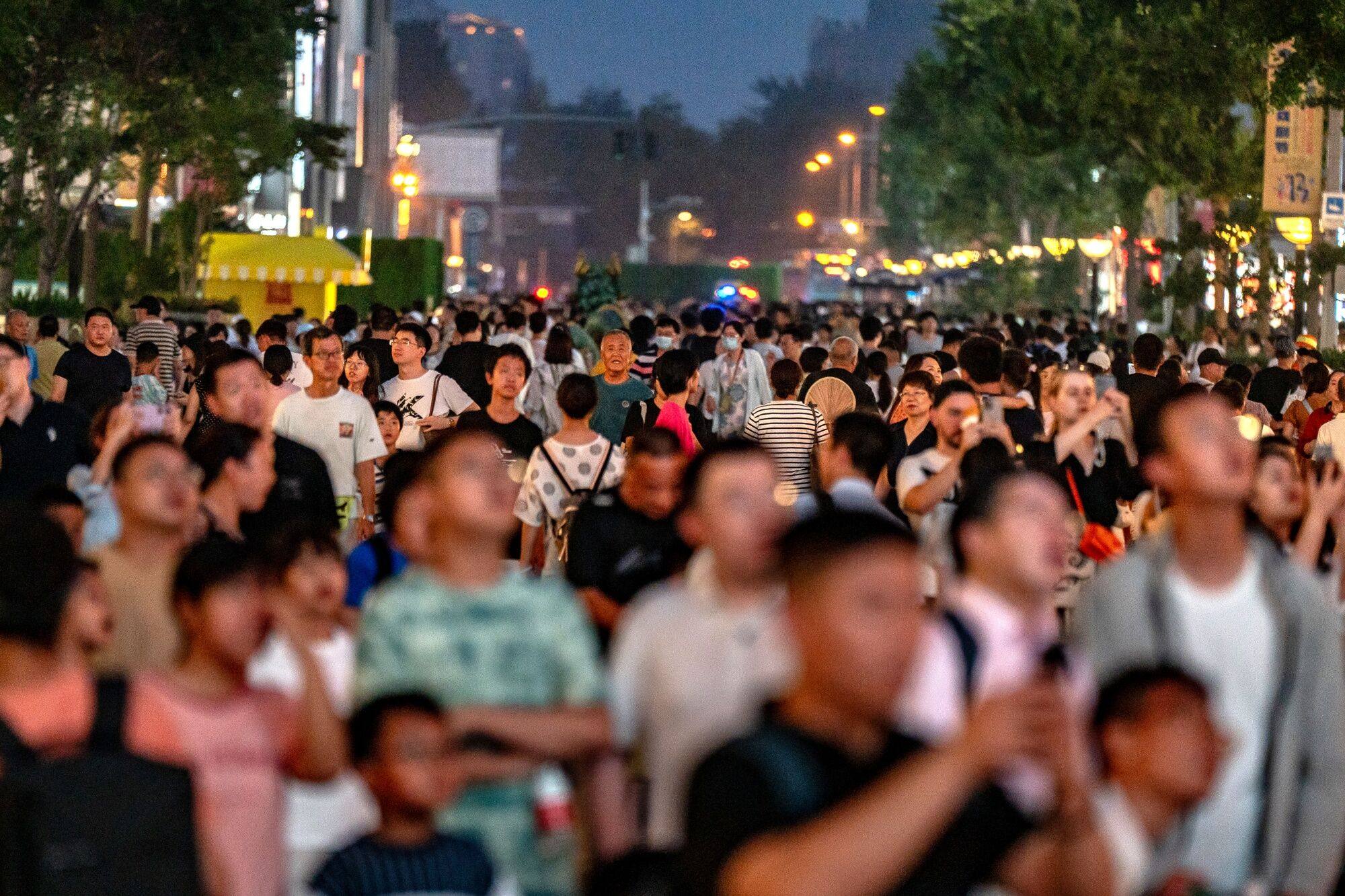 Pedestrians are pictured in the Wangfujing shopping district in Beijing on Monday. A long-term study has revealed changing attitudes about the reasons for being poor in China, and a signal of growing discontent. Photo: Bloomberg