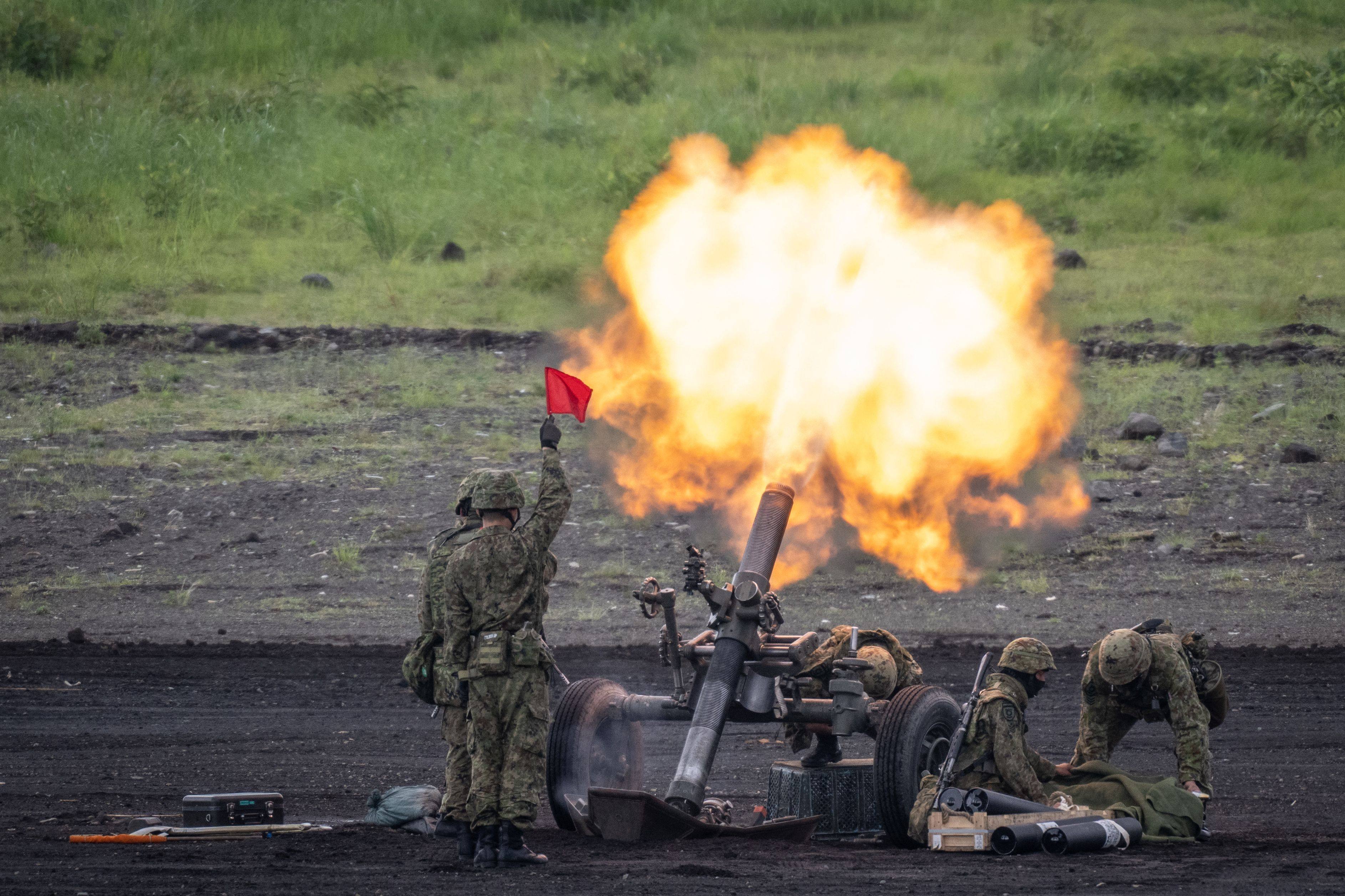 Japanese troops operate a howitzer during a live-fire exercise in Gotemba, central Japan, on May 26. Photo: AFP