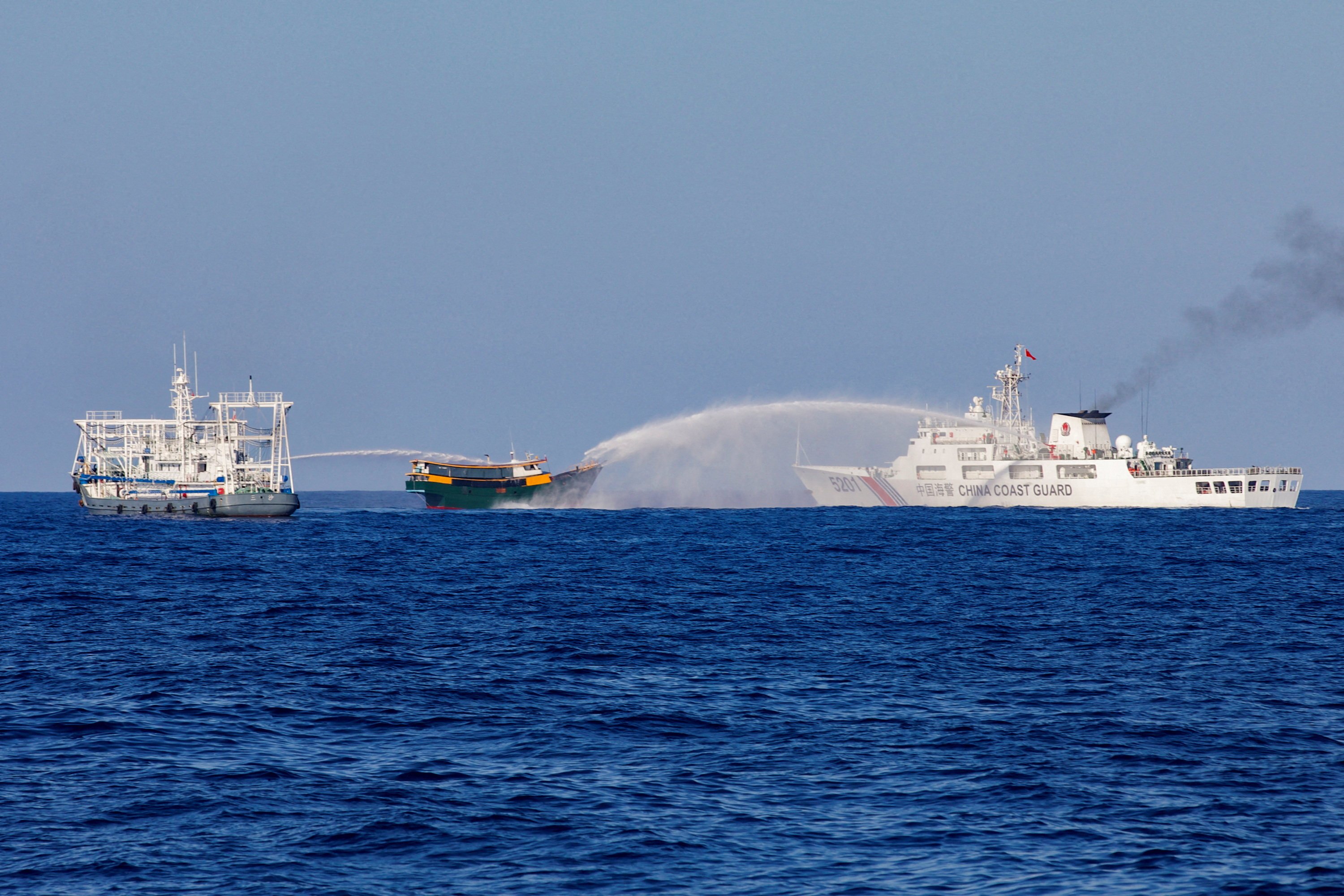Chinese coastguard vessels fire water cannons towards a Philippine resupply vessel en route to the Second Thomas Shoal, in one of a string of recent confrontations in the South China Sea. Photo: Reuters