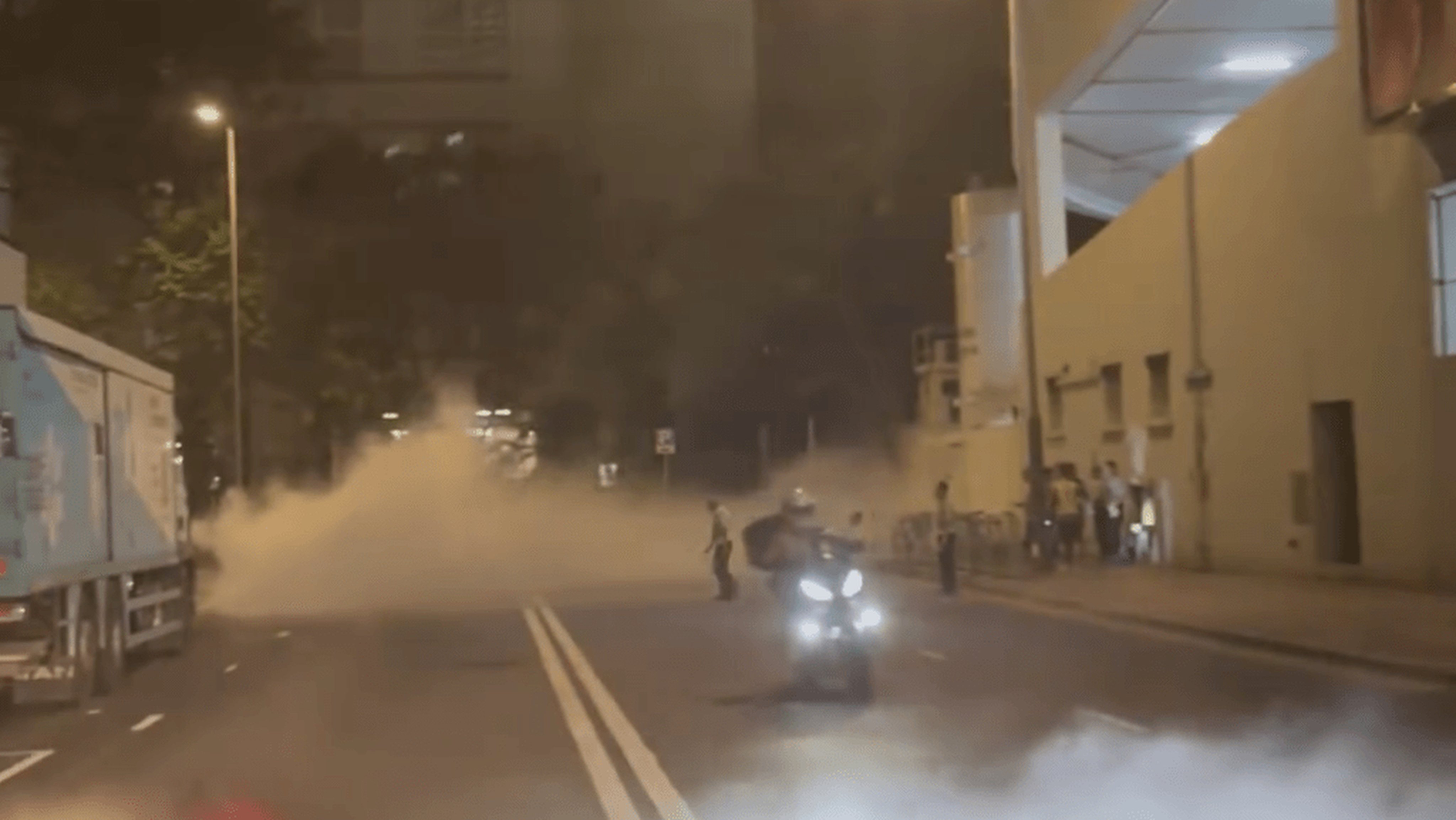 A motorcyclist was seen driving through the smoke in the clip, while two security guards tried to direct traffic as pedestrians looked on. Photo: Facebook/Jason Ka