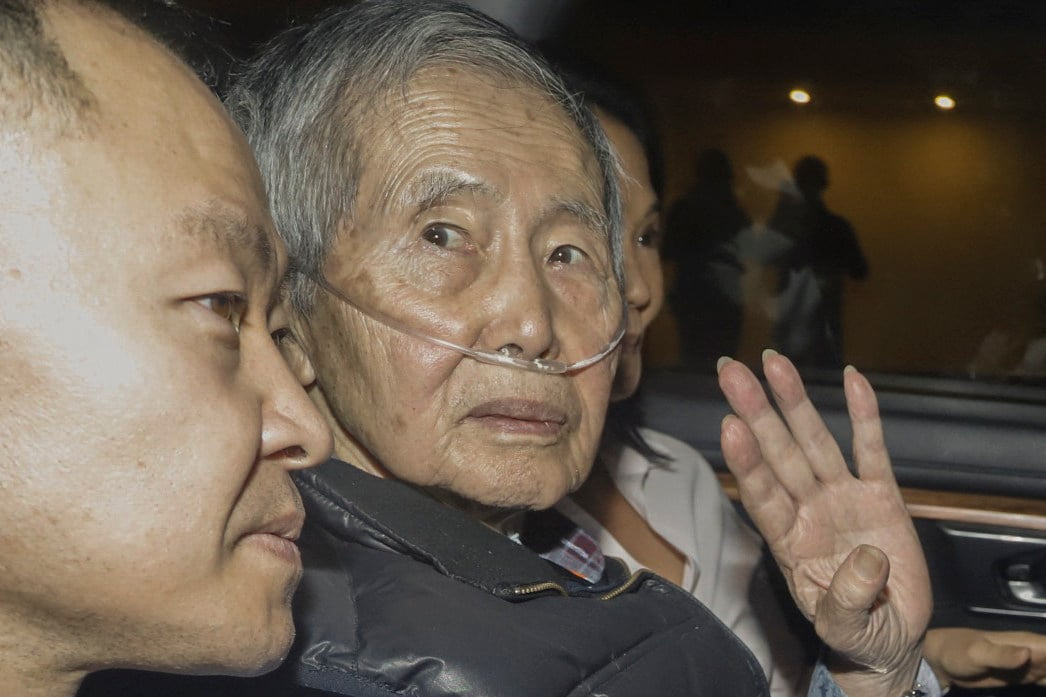 Former Peru president Alberto Fujimori sits between his children Kenji and Keiko upon his release from prison in Lima, Peru on December 6. Photo: AFP