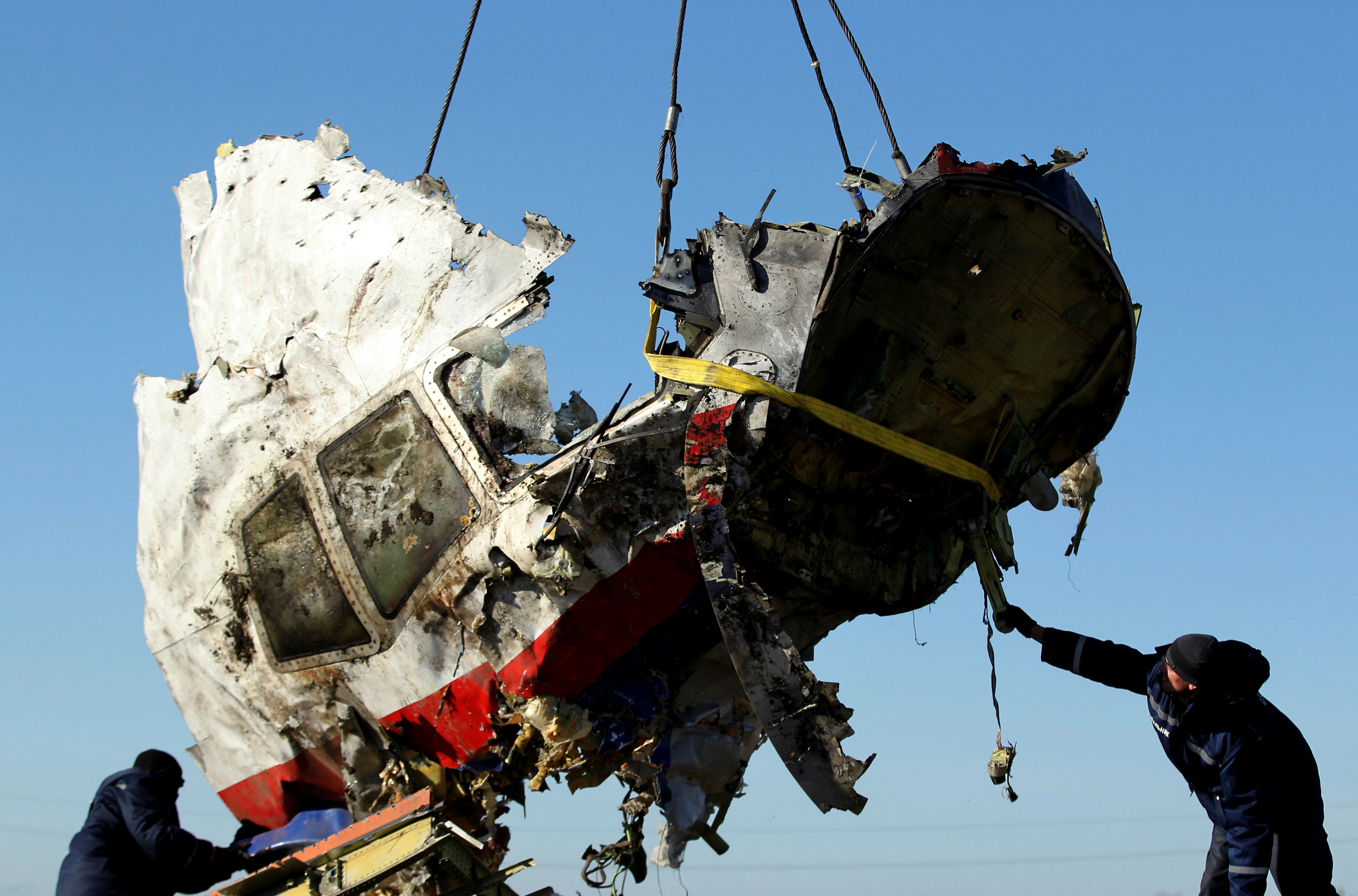 Workers transport a piece of the Malaysia Airlines flight MH17 wreckage at the site the crash in Donetsk, eastern Ukraine, in 2014. Photo: Reuters