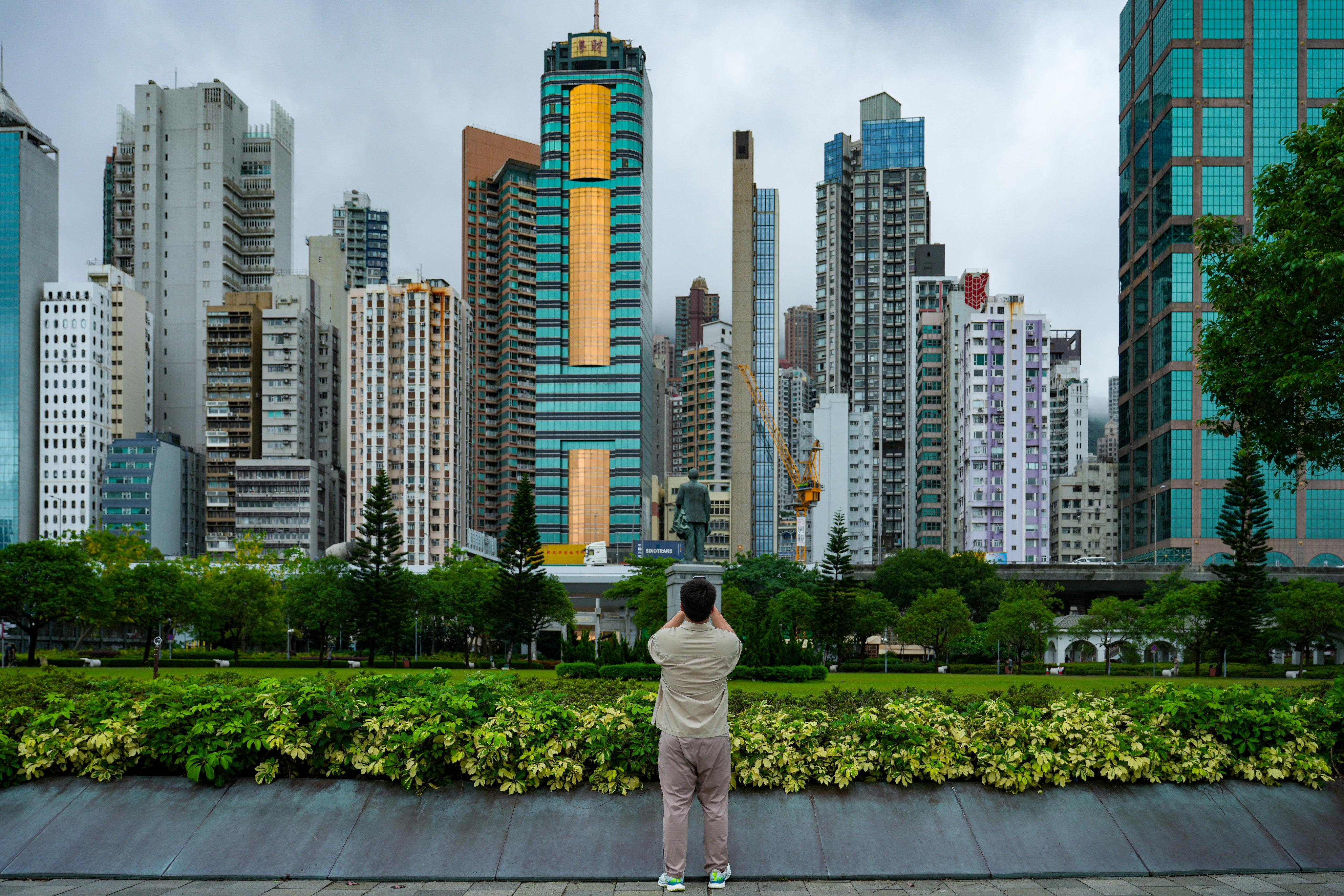 A man takes pictures at Sun Yat Sen Memorial Park, Sai Ying Pun. Hong Kong unveiled plans for a multi-tranche sale of green bonds in dollar, euro and offshore yuan currencies to raise funds for financing projects under the government’s green bond framework. Photo: Sam Tsang