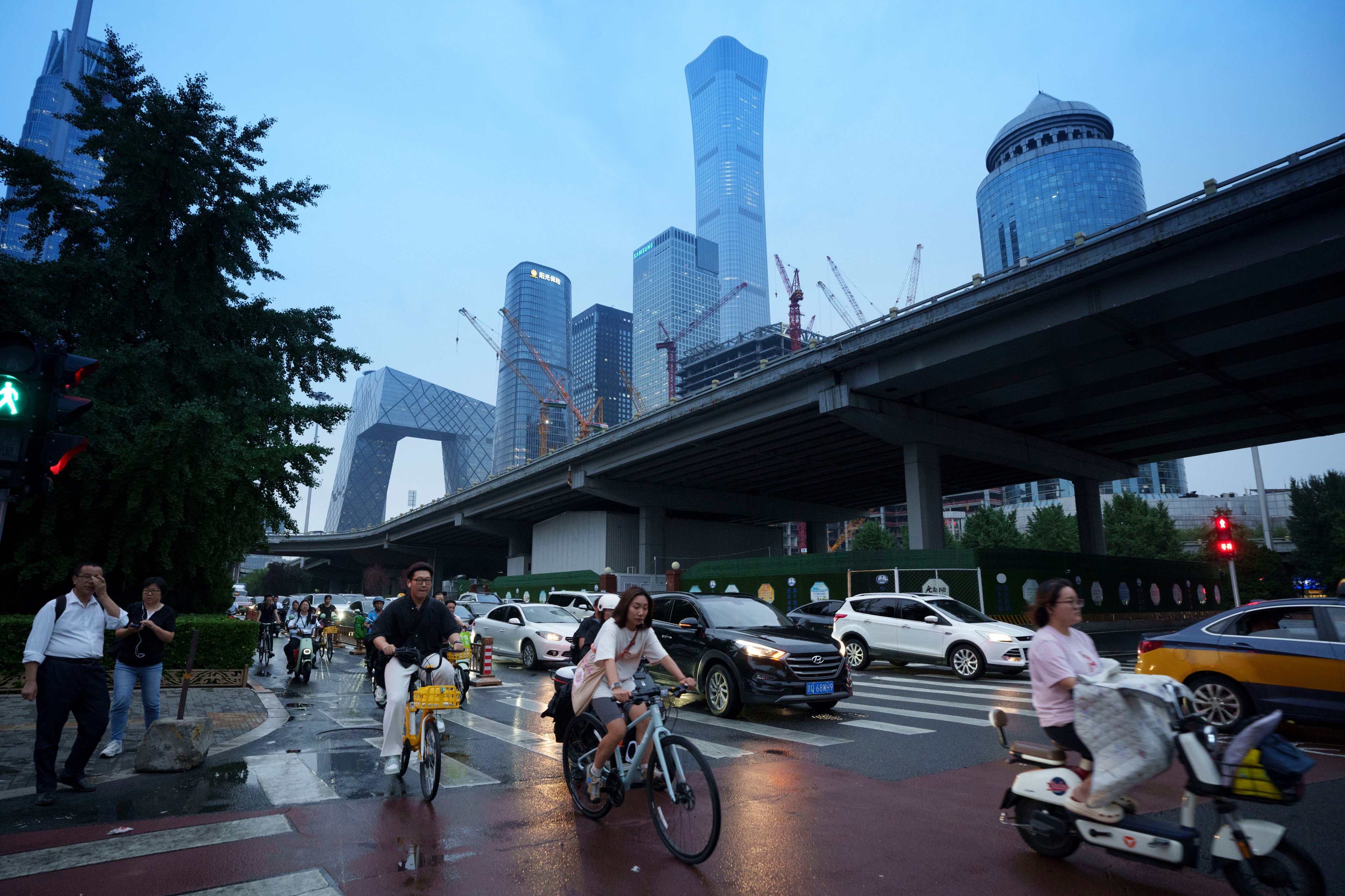 Pedestrians cross an intersection with the background of the central business district in Beijing. China’s Communist Party is holding a four-day meeting that is expected to lay out the economic strategy for the next decade. Photo: AP Photo