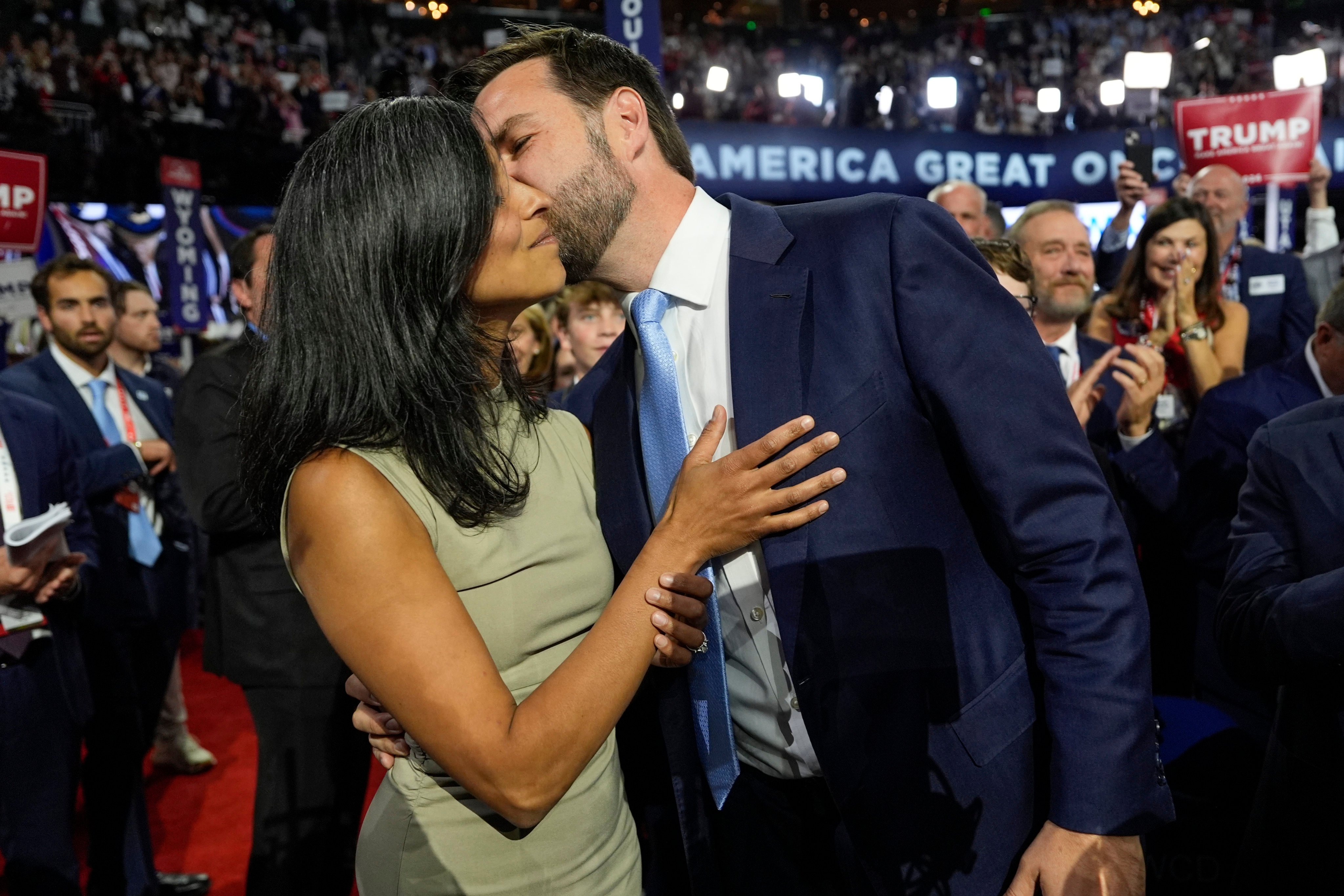 Republican vice presidential candidate Sen. JD Vance, R-Ohio, kisses his wife Usha Chilukuri Vance as they arrive on the floor during the first day of the 2024 Republican National Convention at the Fiserv Forum, Monday, July 15, 2024, in Milwaukee. (AP Photo/Carolyn Kaster)
