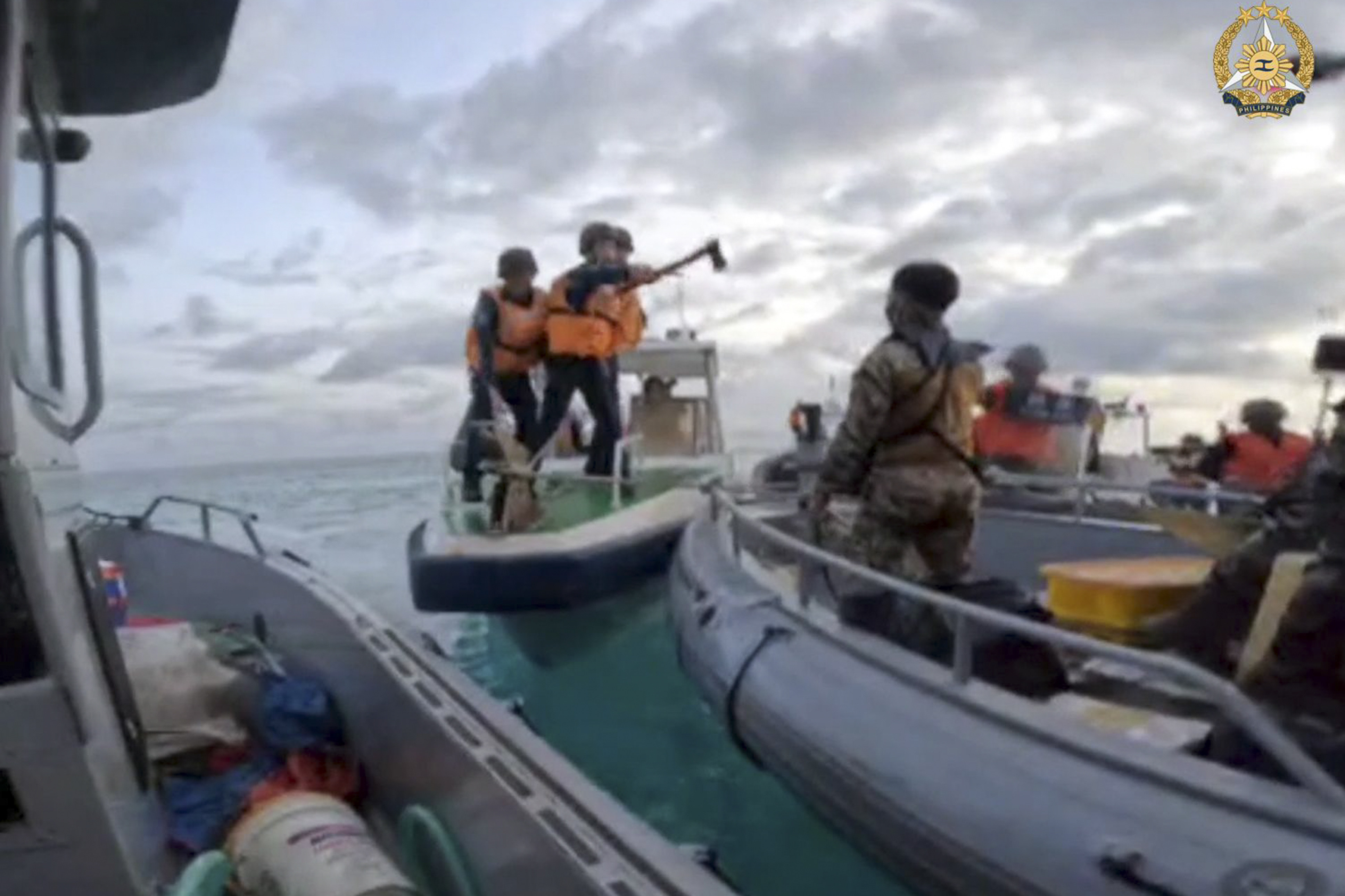 A Chinese coastguard member holds an axe as they approach Philippine troops on a resupply mission in the Second Thomas Shoal at the disputed South China Sea on June 17, 2024. Photo: Armed Forces of the Philippines via AP