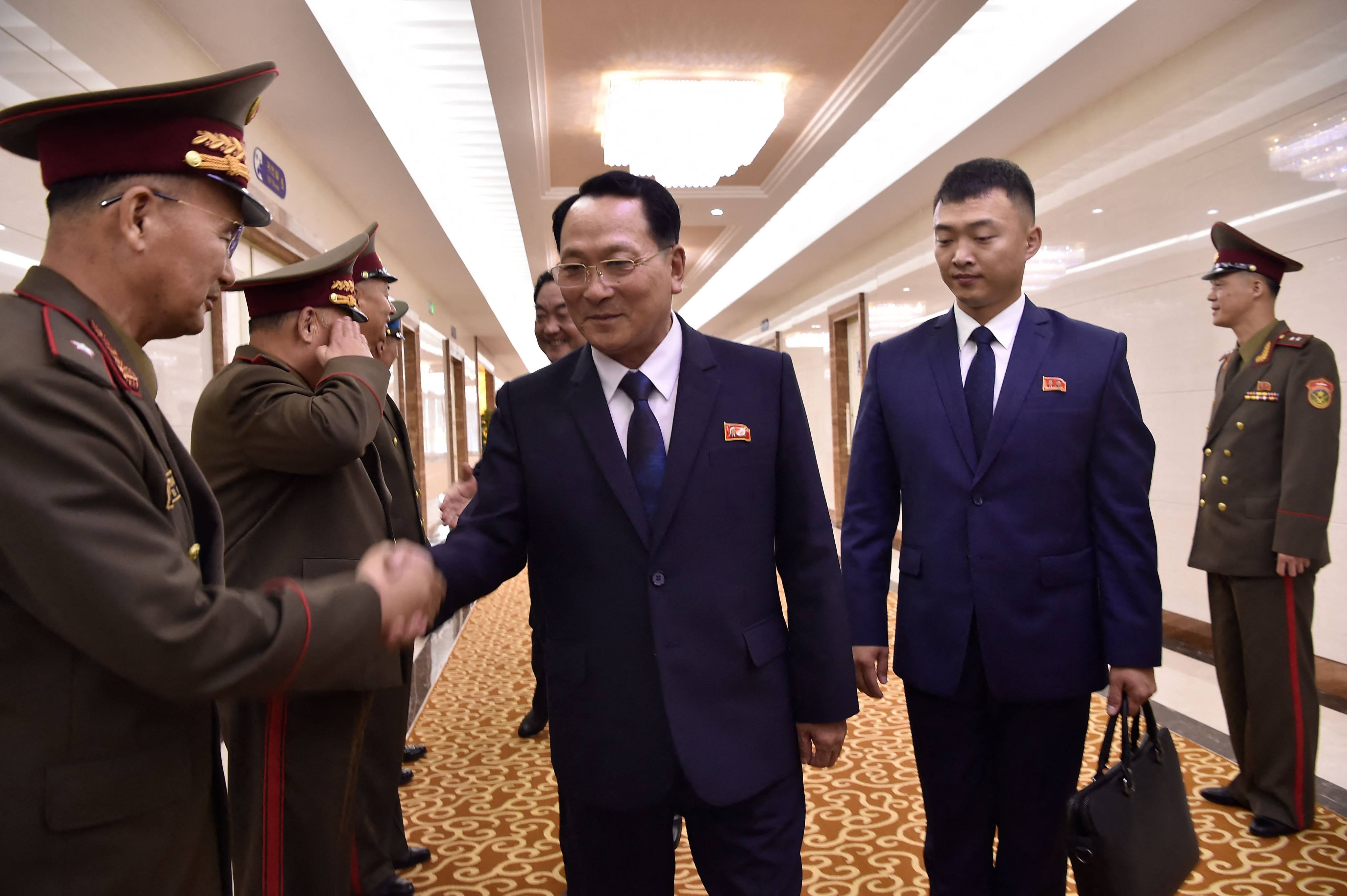 Kim Geum-chol, president of Kim Il-sung Military University, shakes hands with North Korean military officials before departing to Russia from Pyongyang on July 8. Photo: AFP