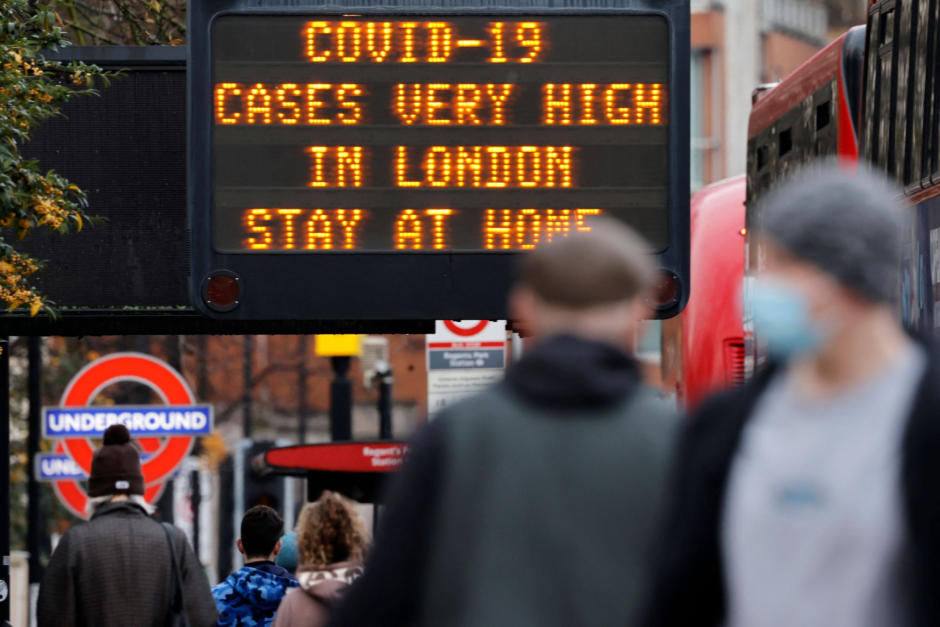 A sign alerts pedestrians that Covid-19 cases are very high in central London in December 2020. Photo: AFP