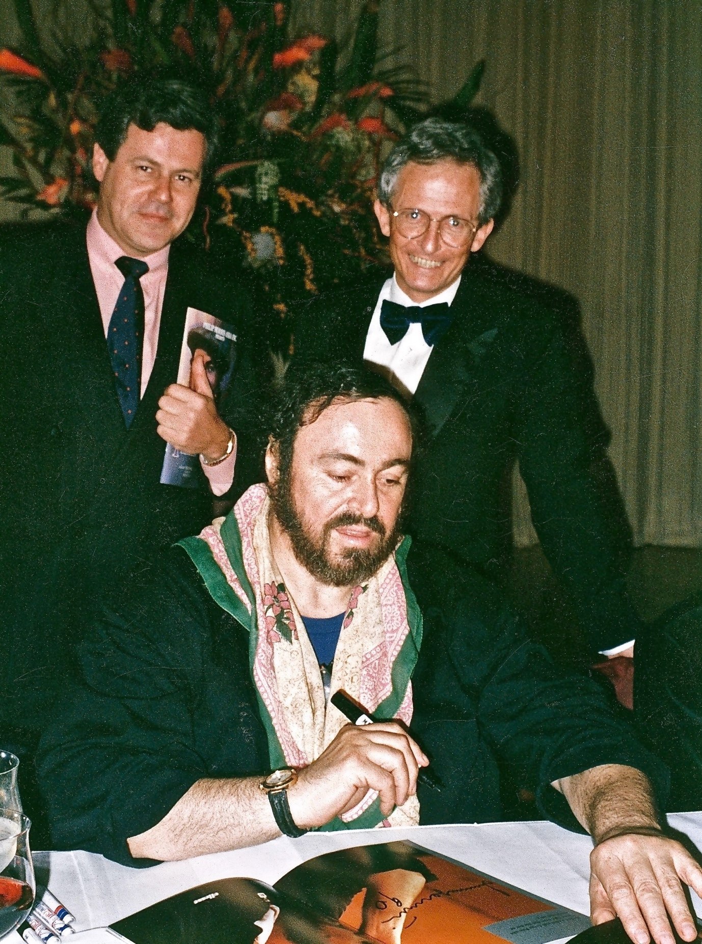 Luciano Pavarotti signs autographs following his first concert in Hong Kong, in February 1990. In his memoir, John Duffus  (right) recalls the time Pavarotti sang a duet with Jiang Zemin in Beijing. Photo courtesy of Blacksmith Books 