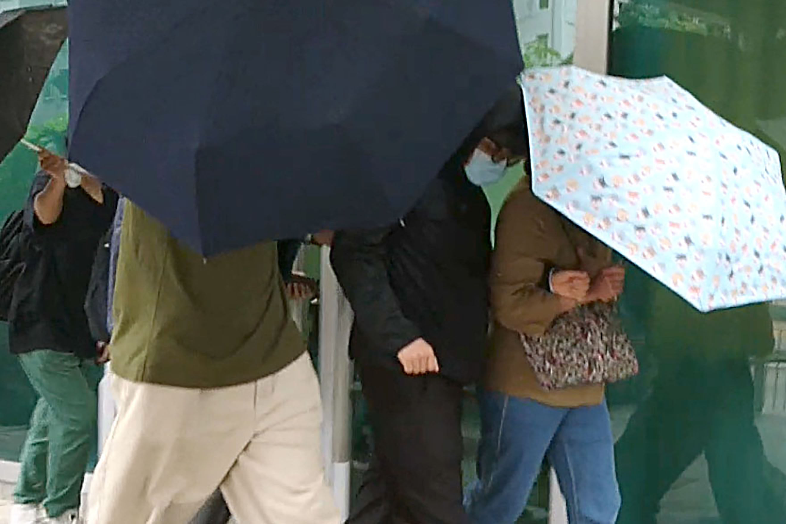 Defendant Chan Pak-yui (masked) is escorted by supporters as he leaves Kowloon City Court on Friday. Photo: Handout