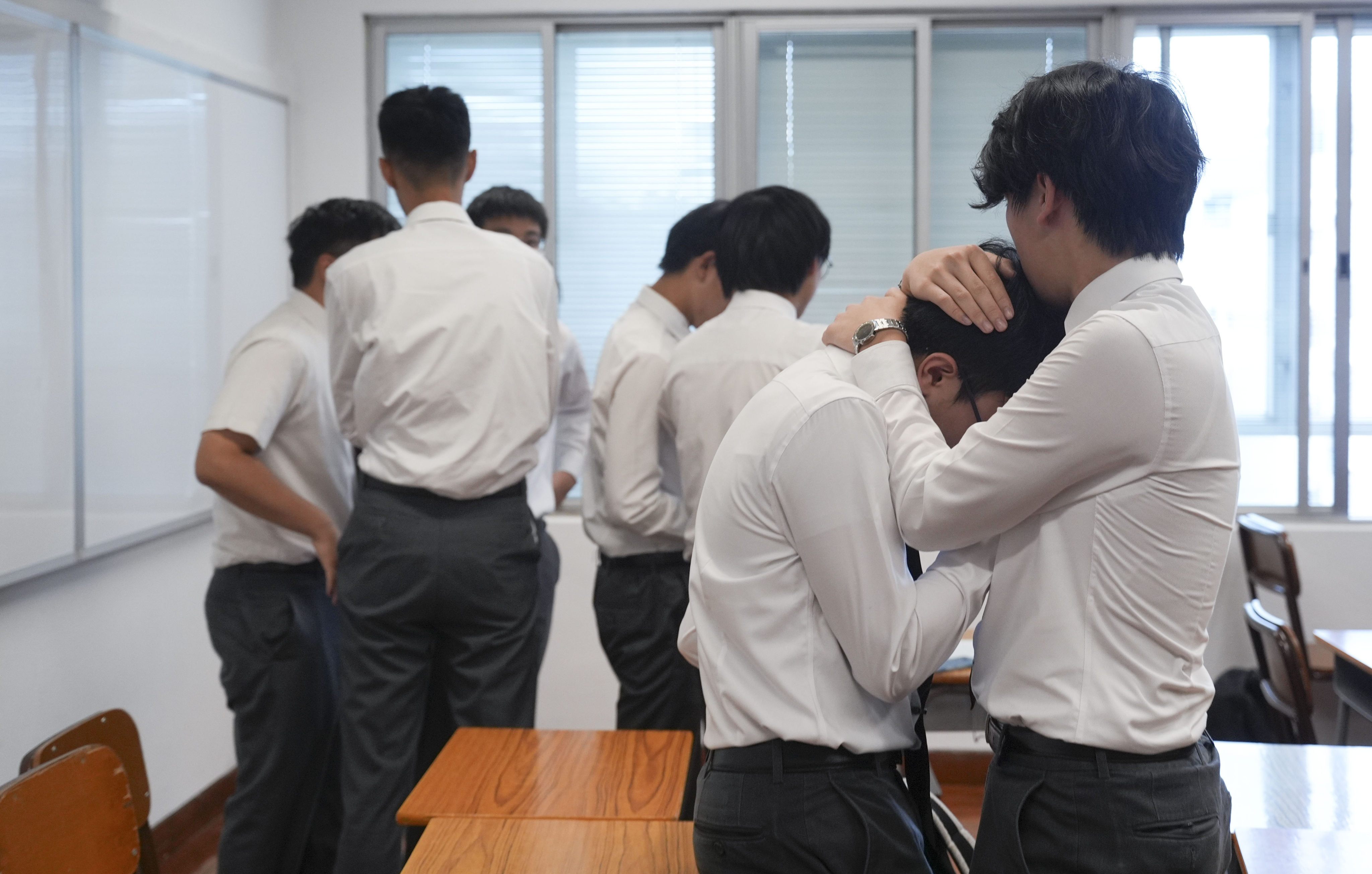 Students of a secondary school in Hong Kong react to their DSE results on July 17. The annual “grand reveal” is a stark reminder of the intense academic pressures our young people face. Photo: Eugene Lee