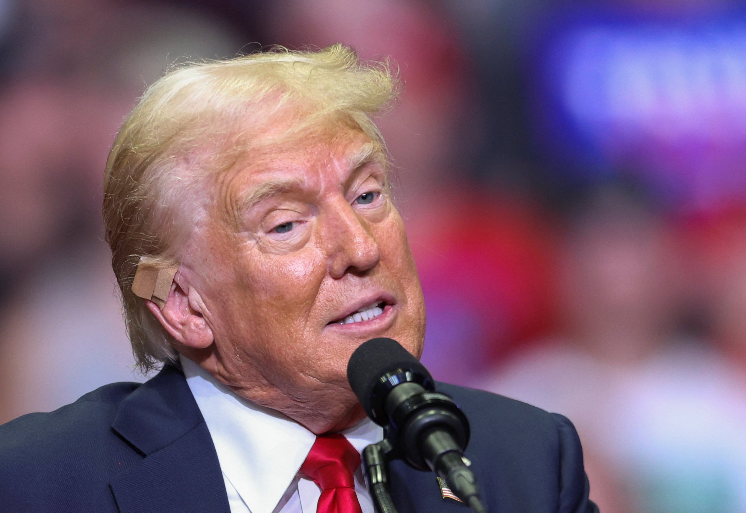 Republican US presidential nominee Donald Trump wears a flesh-coloured bandage on his ear as he holds a campaign rally in Grand Rapids, Michigan, on Saturday. Photo: Reuters