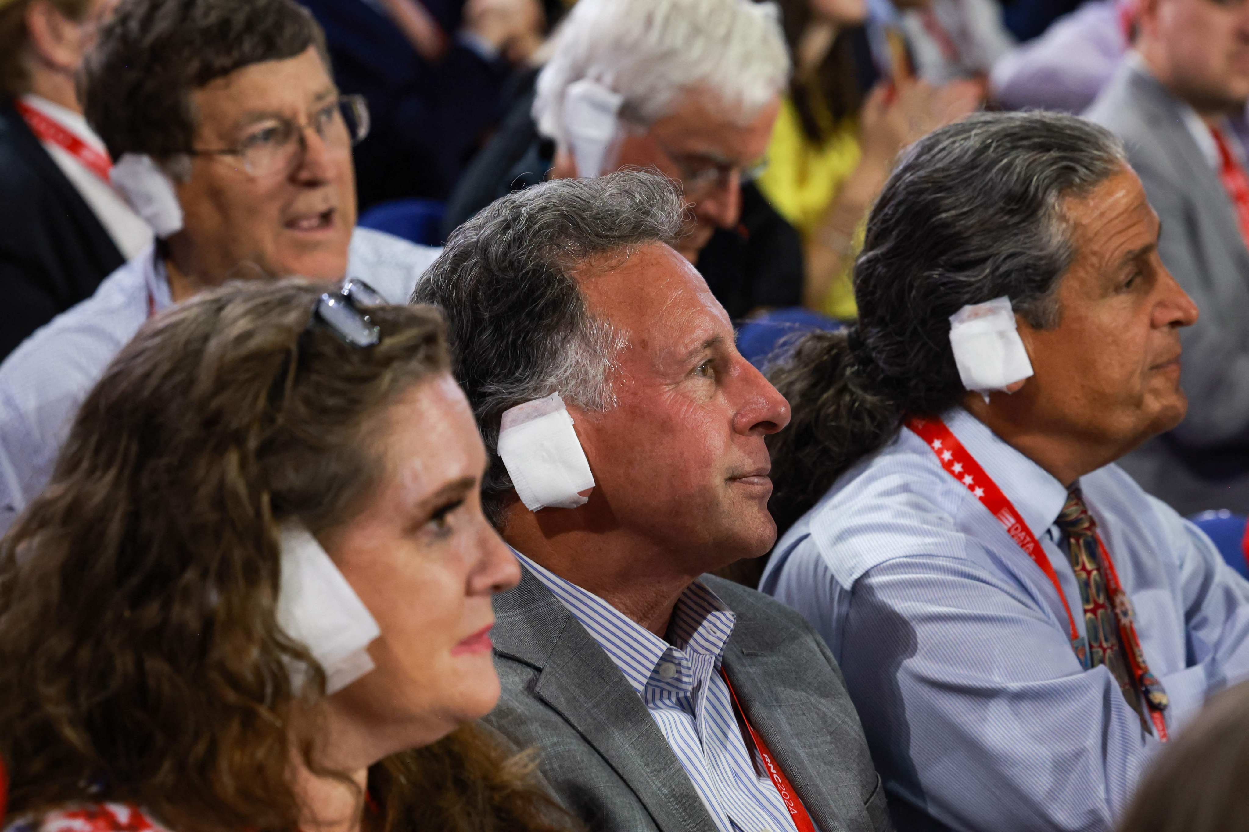 People wear “bandages” on their ears as they watch on the third day of the Republican National Convention on July 17. Photo: AFP