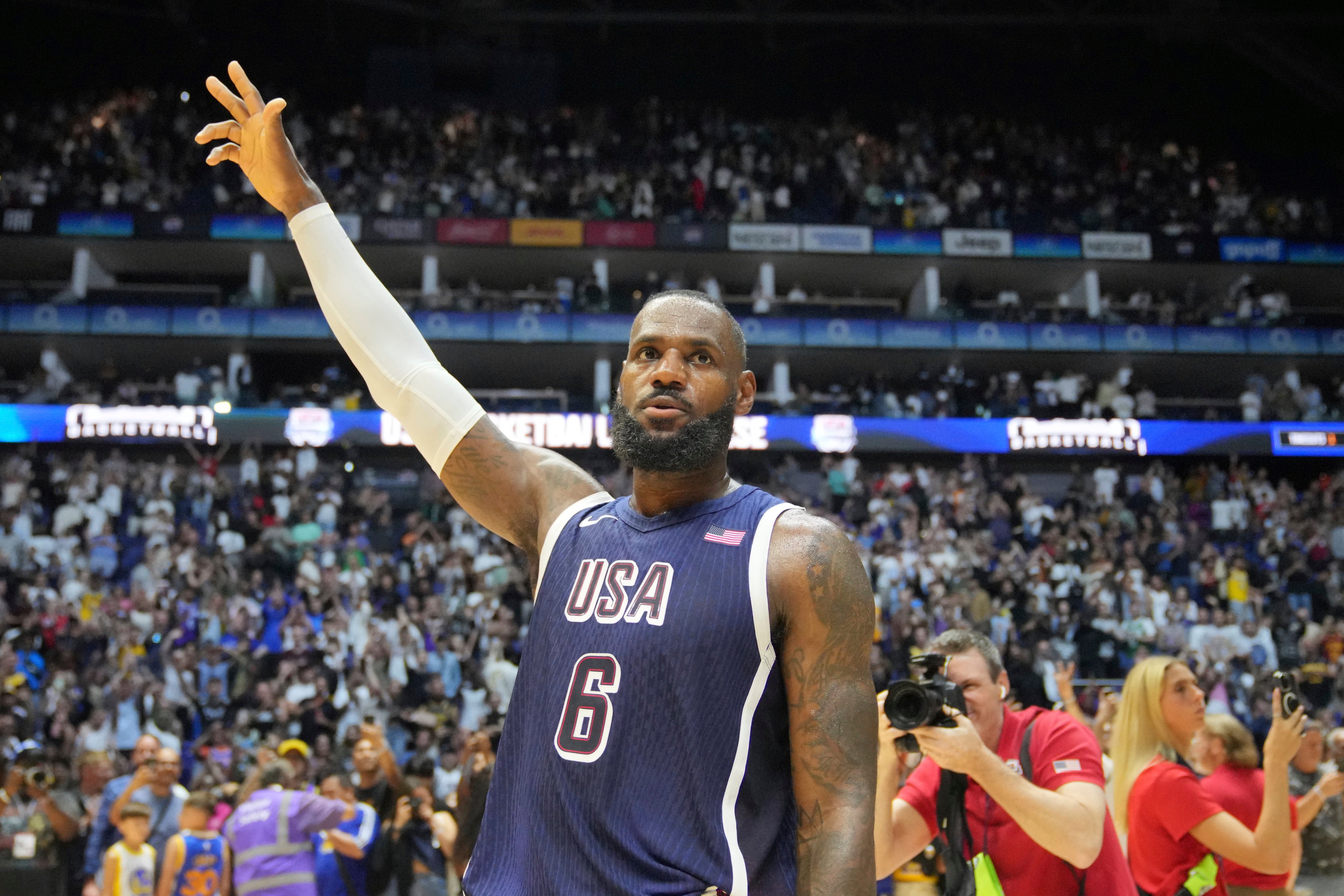 LeBron James waves to the crowd after his points helped the United States prevent a stunnig upset against South Sudan in an Olympic warmup match. Photo: AP