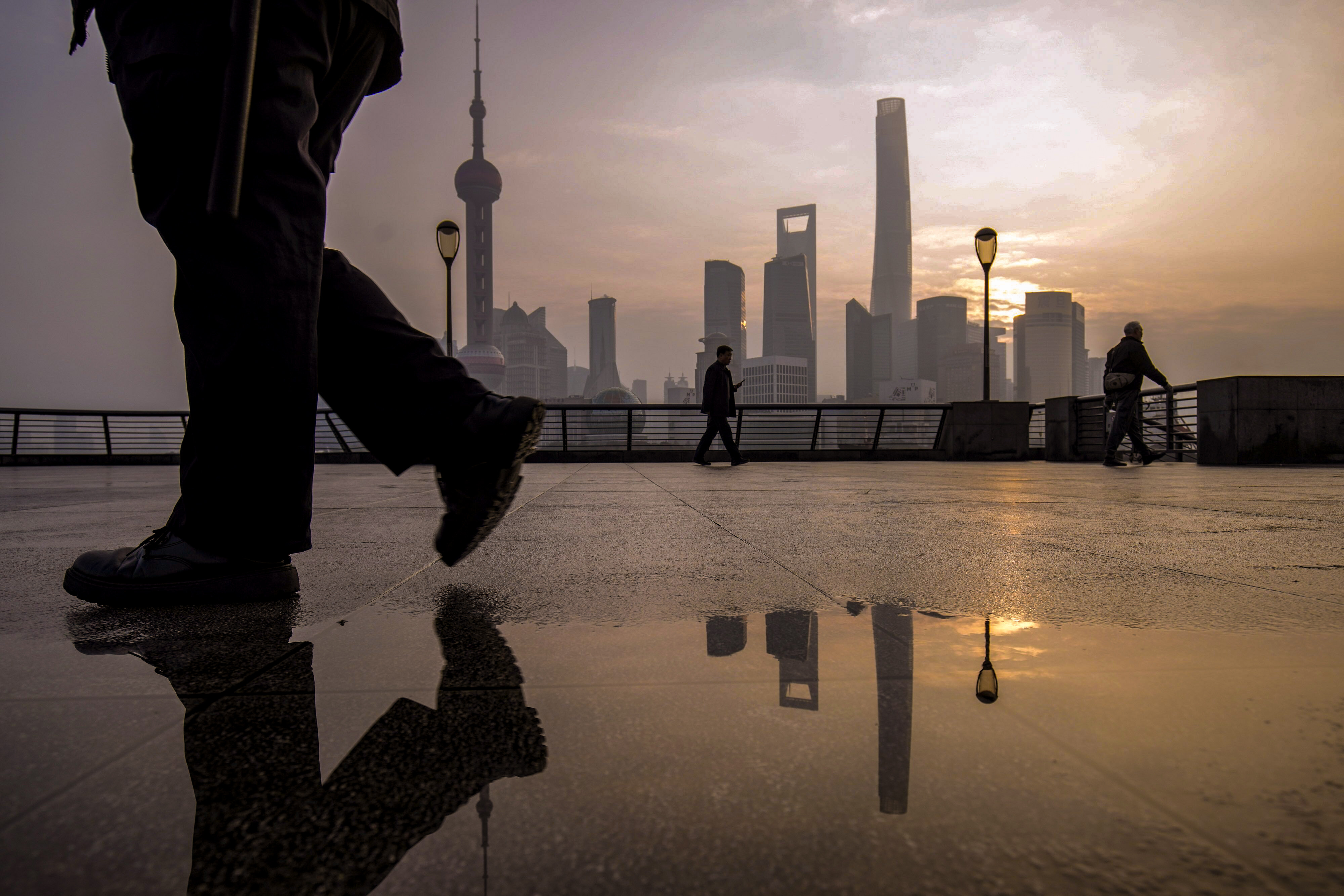 Pedestrians on the Bund in front of buildings in Pudong’s Lujiazui Financial District in Shanghai, China, on Tuesday, Jan. 9, 2024. Photo: Bloomberg