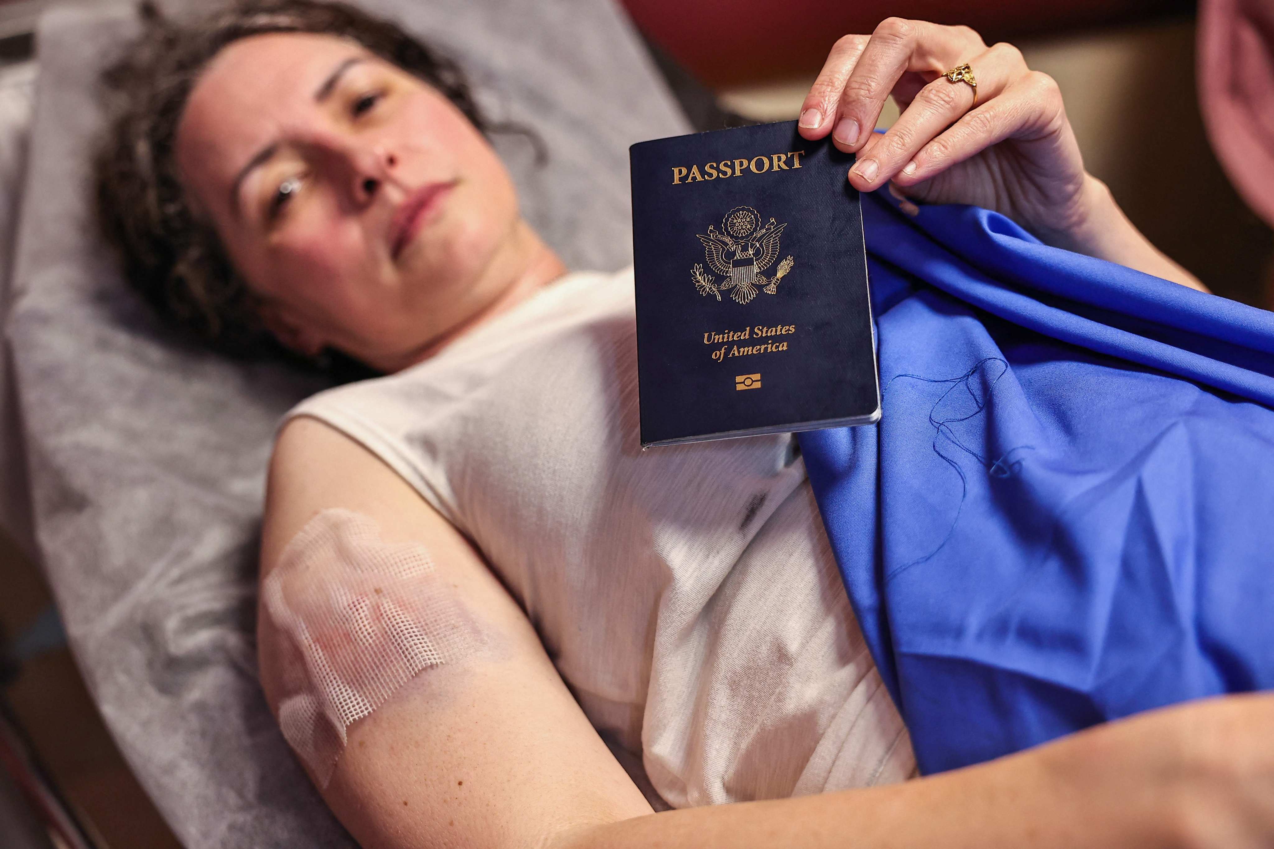 A member of a group of foreign volunteers shows her US passport as she receives treatment at Nablus’s Rafidia Hospital, after an attack by Israeli settlers in Qusra village, occupied West Bank, on Sunday. Photo: AFP