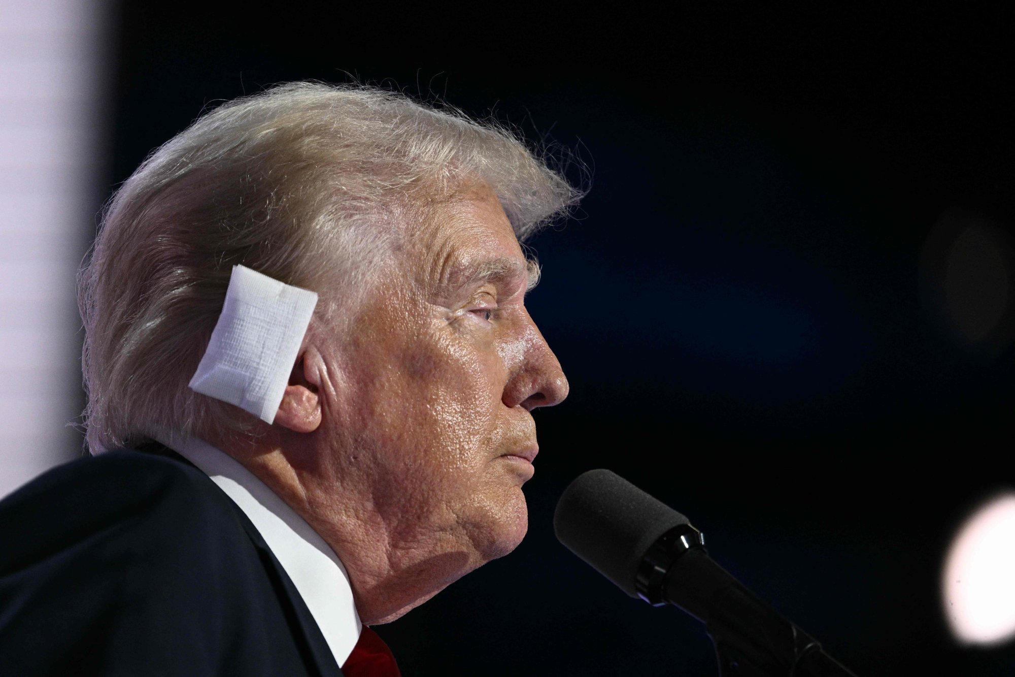 Donald Trump, wearing a bandage on his ear after he was injured during an assassination attempt several days earlier, speaks onstage during the last day of the 2024 Republican National Convention at the Fiserv Forum in Milwaukee, Wisconsin, on July 18. Photo: AFP