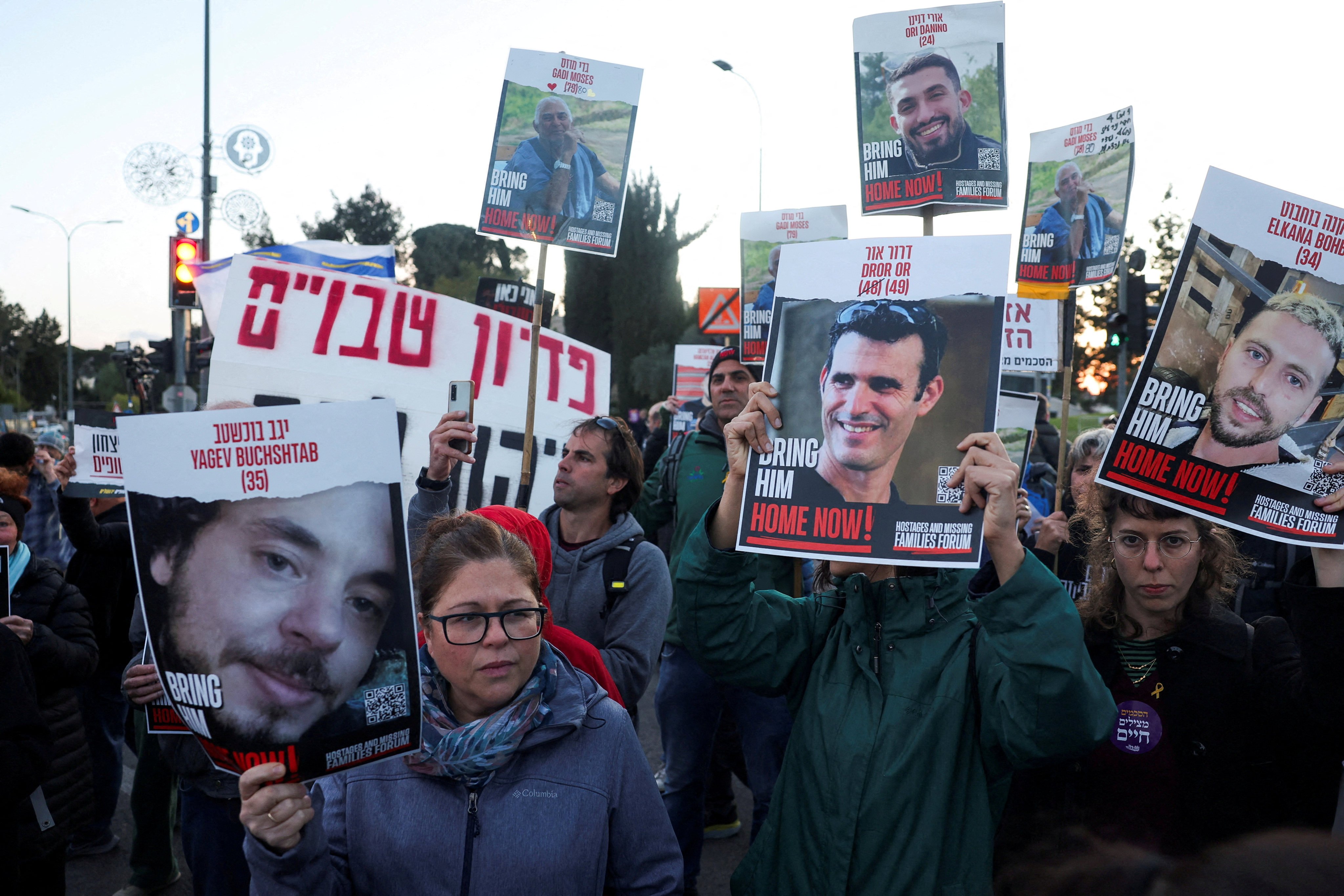 A woman holds a photo of Israeli hostage Yagev Buchshtab during a protest calling for a deal and the release of the hostages held in Gaza on April 9. Photo: Reuters