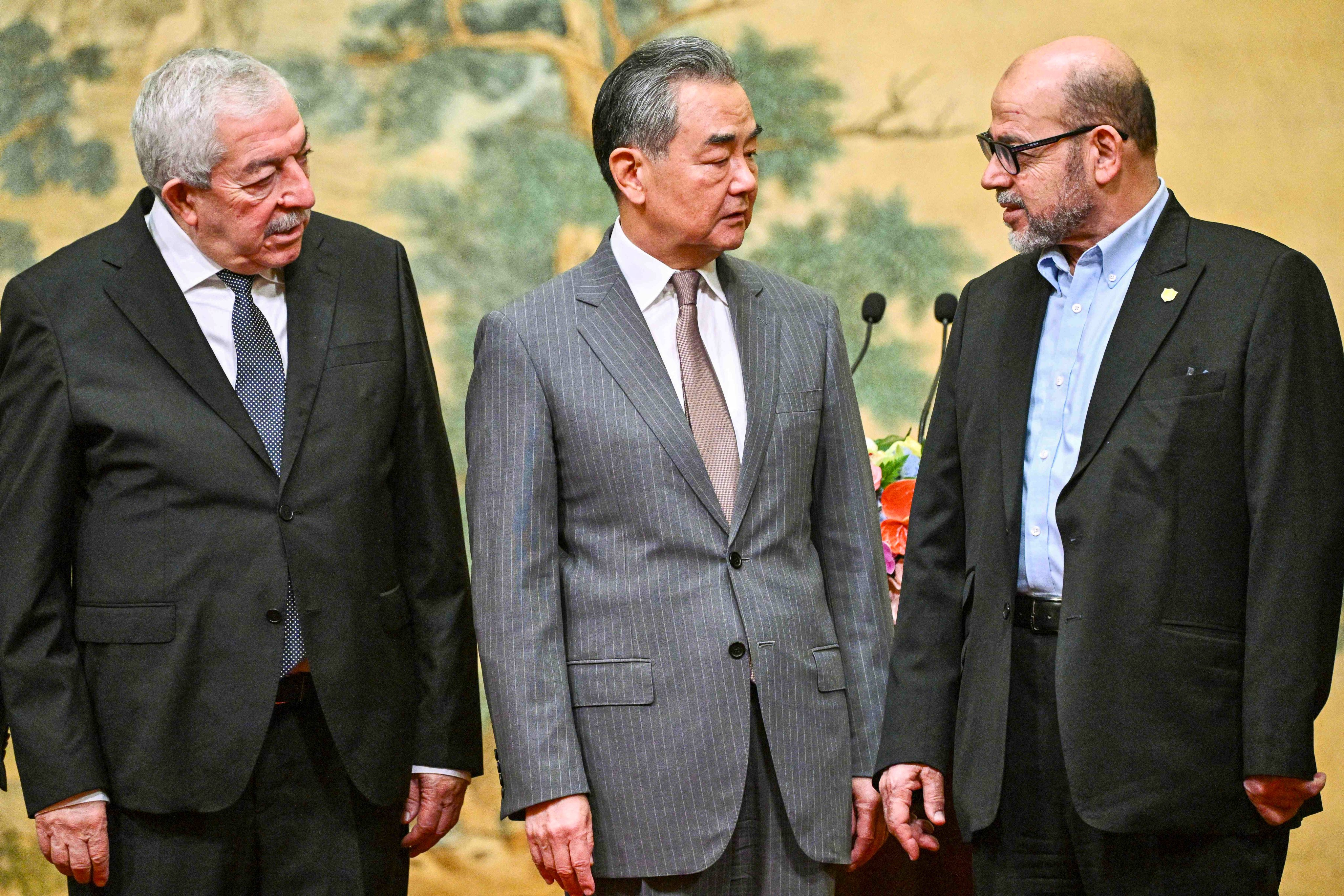 (From left) Mahmoud al-Aloul, vice-chairman of the Central Committee of Fatah, Chinese Foreign Minister Wang Yi and senior Hamas member Mousa Abu Marzouk at the Diaoyutai State Guesthouse in Beijing on Tuesday. Photo: AFP