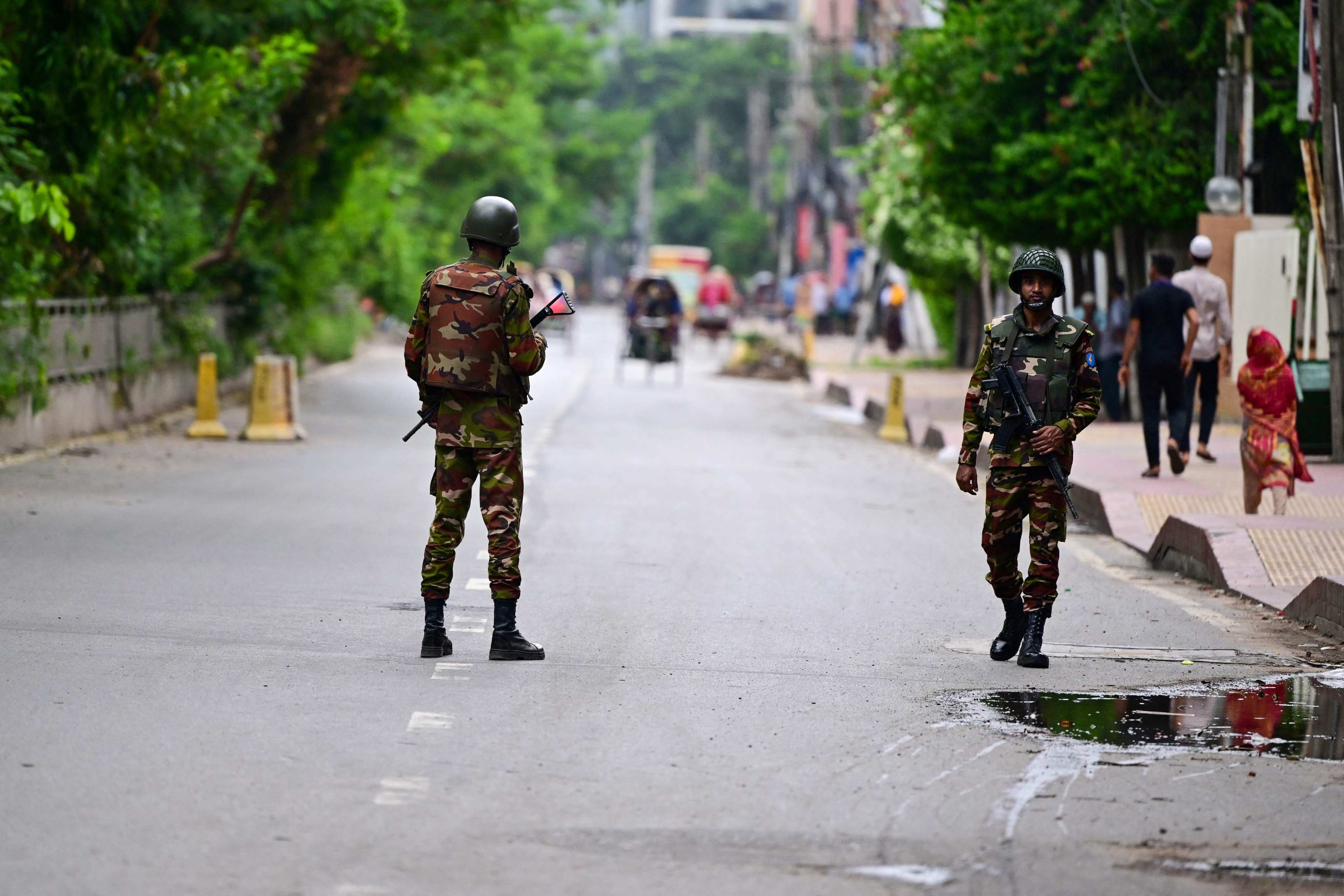 Bangladeshi soldiers stand guard along a street during a curfew amid the anti-quota protests, in Dhaka on Monday. Photo: AFP