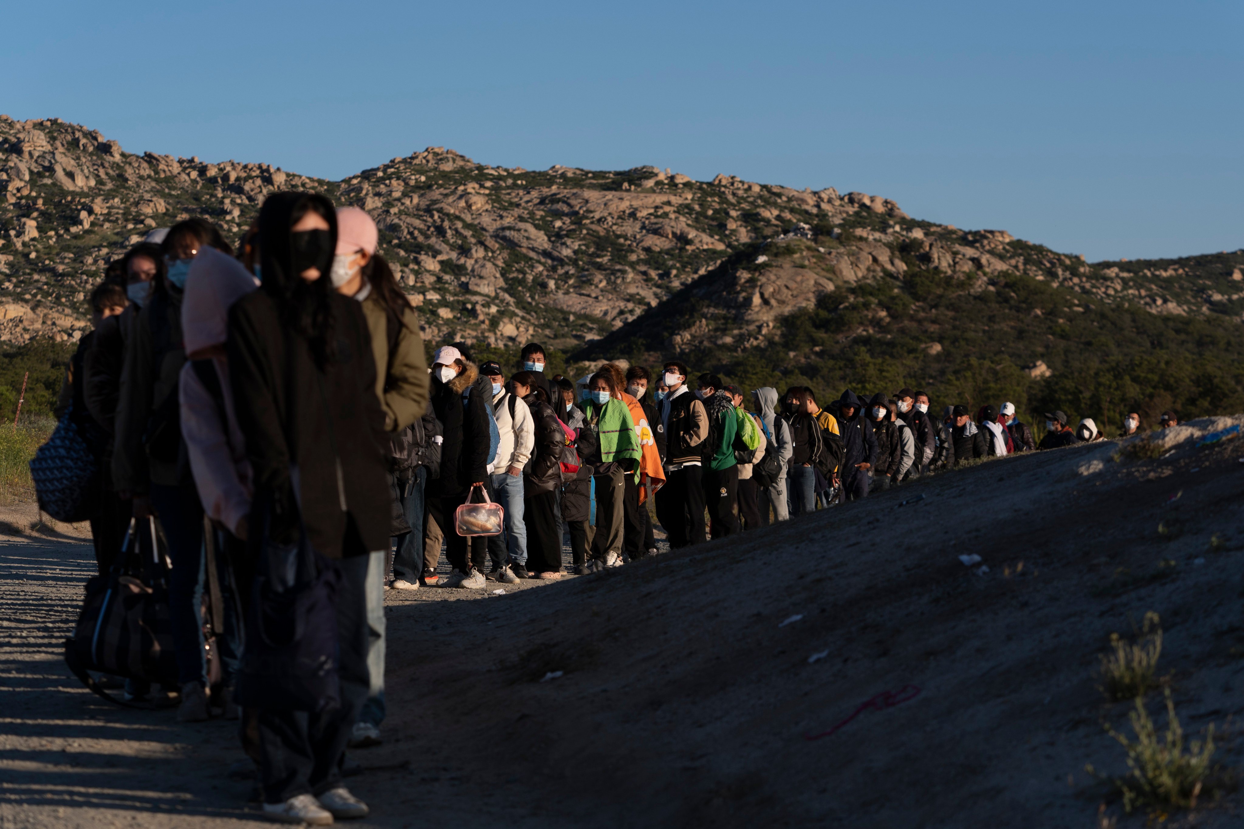 Chinese migrants wait to be processed after crossing the US-Mexico border on May 8, near Jacumba Hot Springs, California. Photo: AP