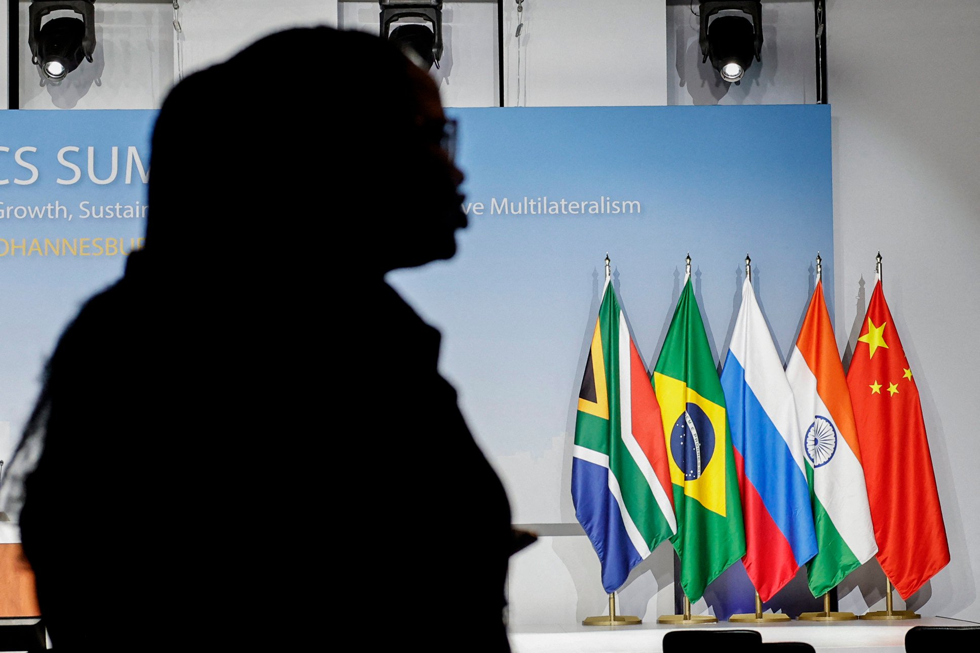 A person stands near the flags of South Africa, Brazil, Russia, India and China during the Brics summit in Johannesburg, on August 24, 2023, before the grouping’s expansion. Photo: AFP