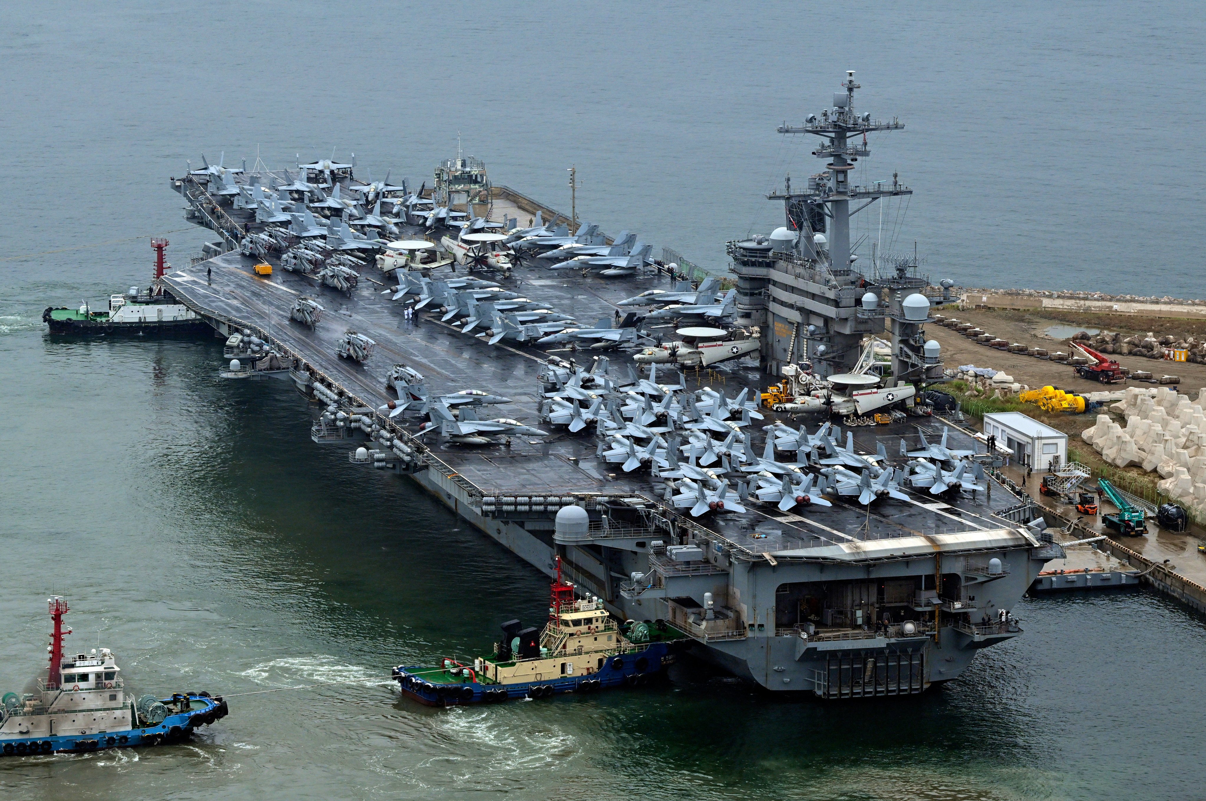 The Theodore Roosevelt (CVN 71), an American nuclear-powered aircraft carrier is  anchored in Busan. Three Chinese accused of illegally photographing the ship say they were curious. Photo: AP