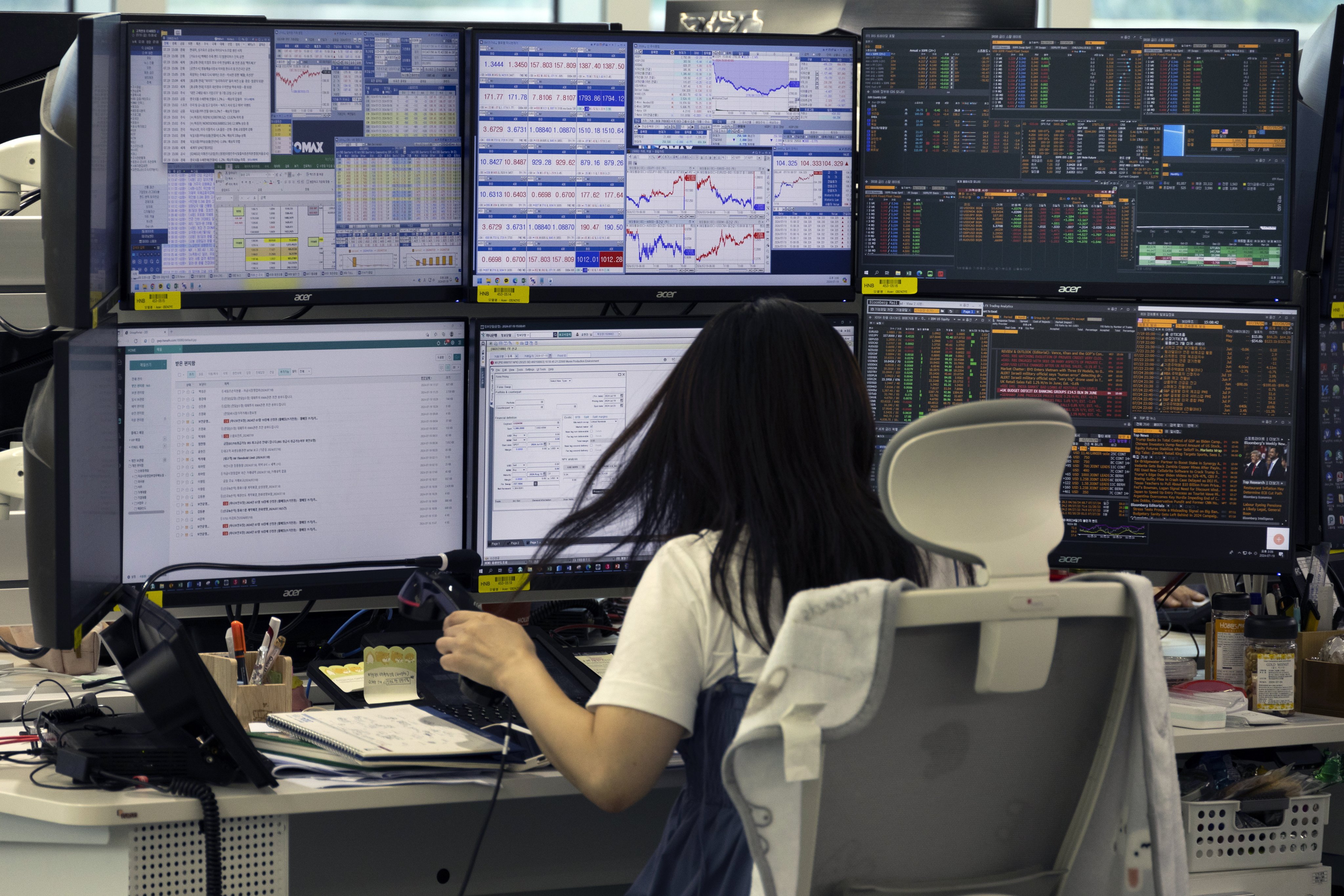 A dealer in front of monitors at the Hana Bank in Seoul on 19 July 2024. Photo: EPA-EFE